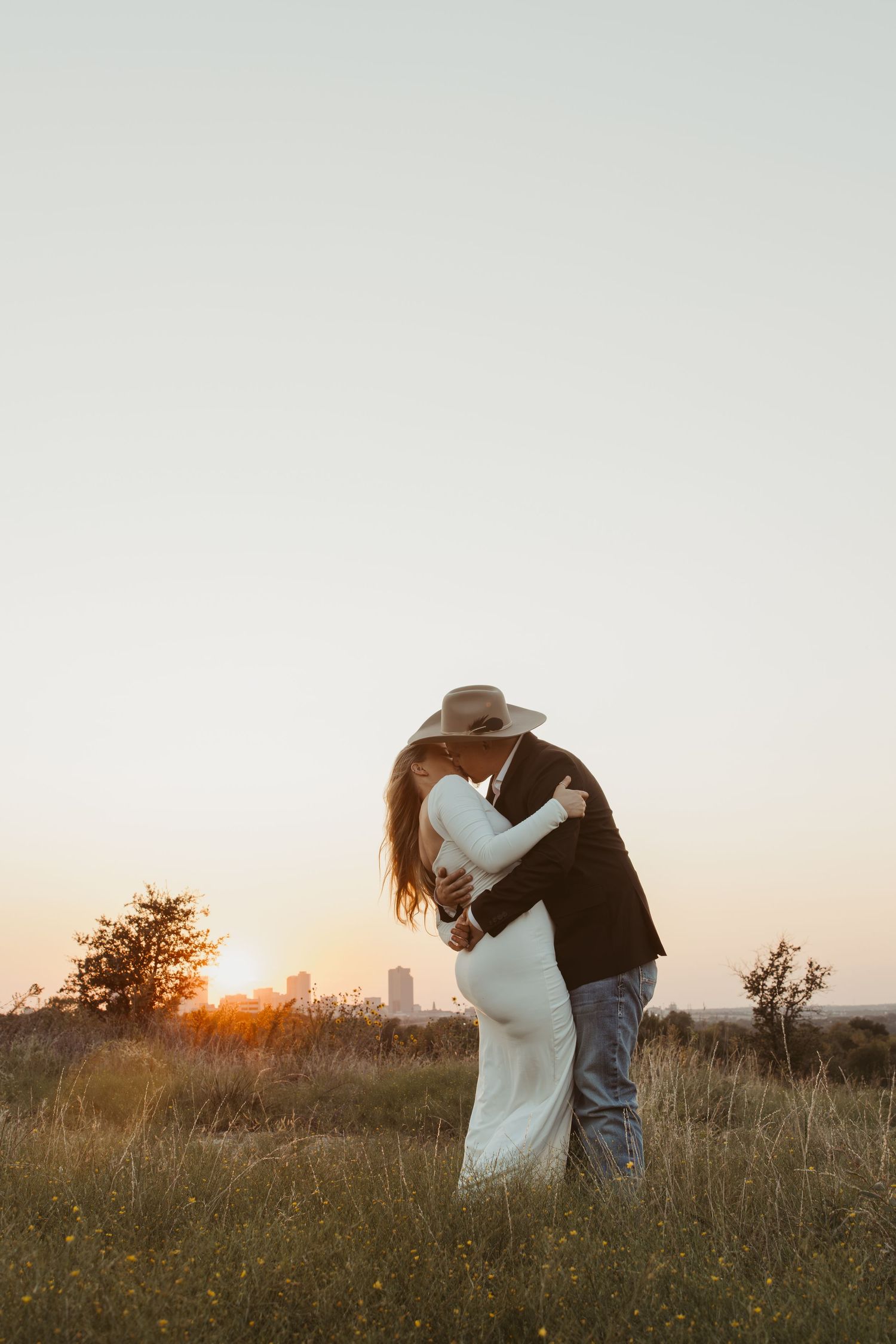 A romantic couple embraces in a golden field at sunset with multiple poses captured in a photo collage.