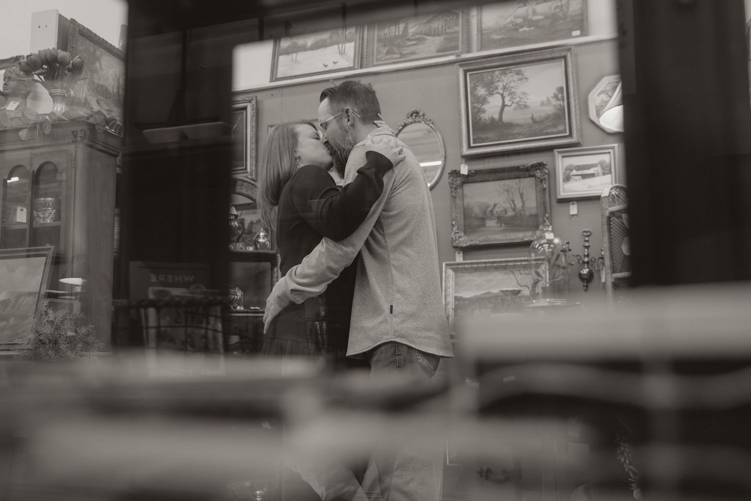 Black and white photo shows people dancing in a dimly lit bar or club setting.