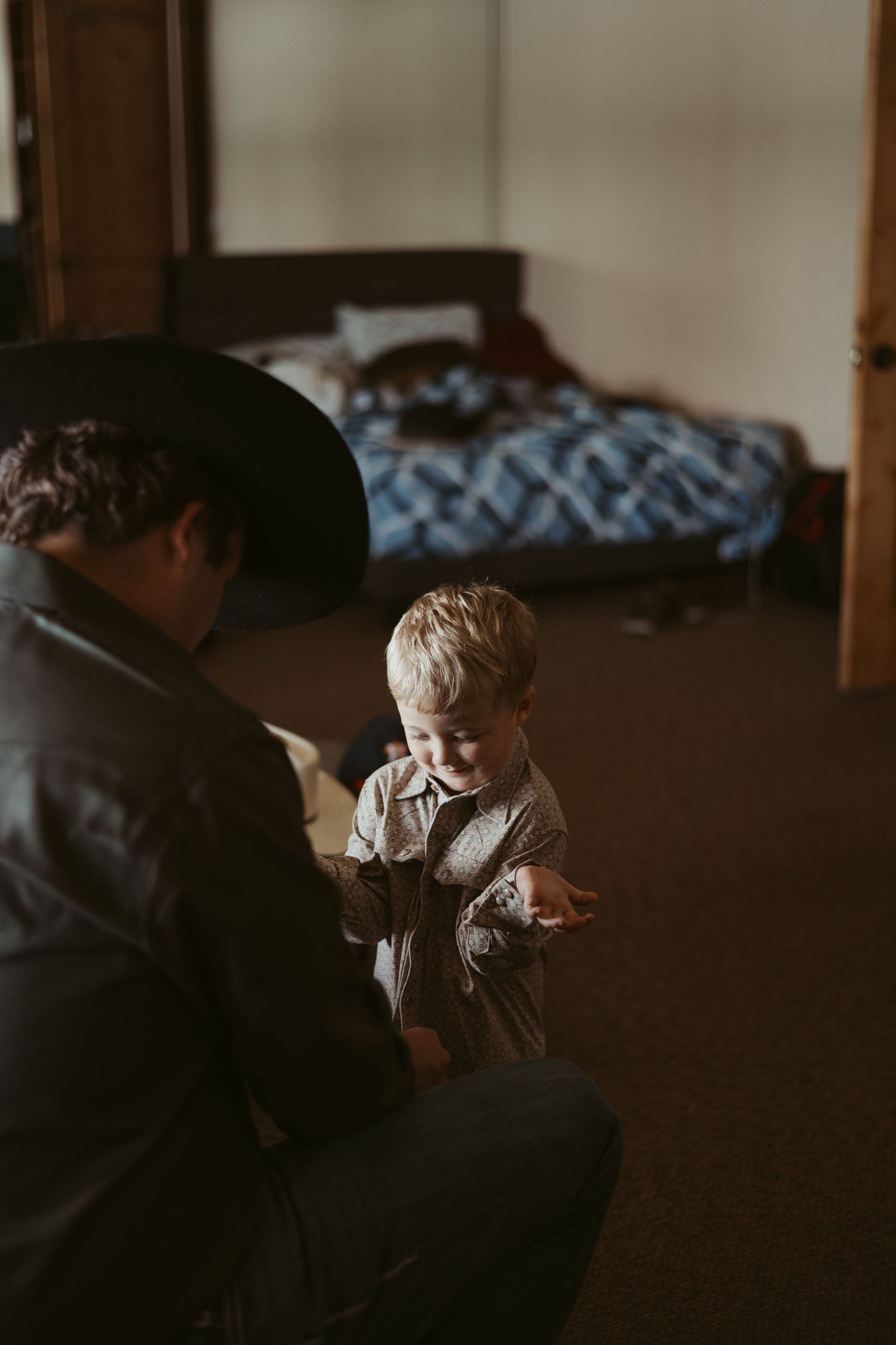 Intimate indoor scene with soft natural lighting and muted tones creating a cozy atmosphere. Wedding photographer DFW