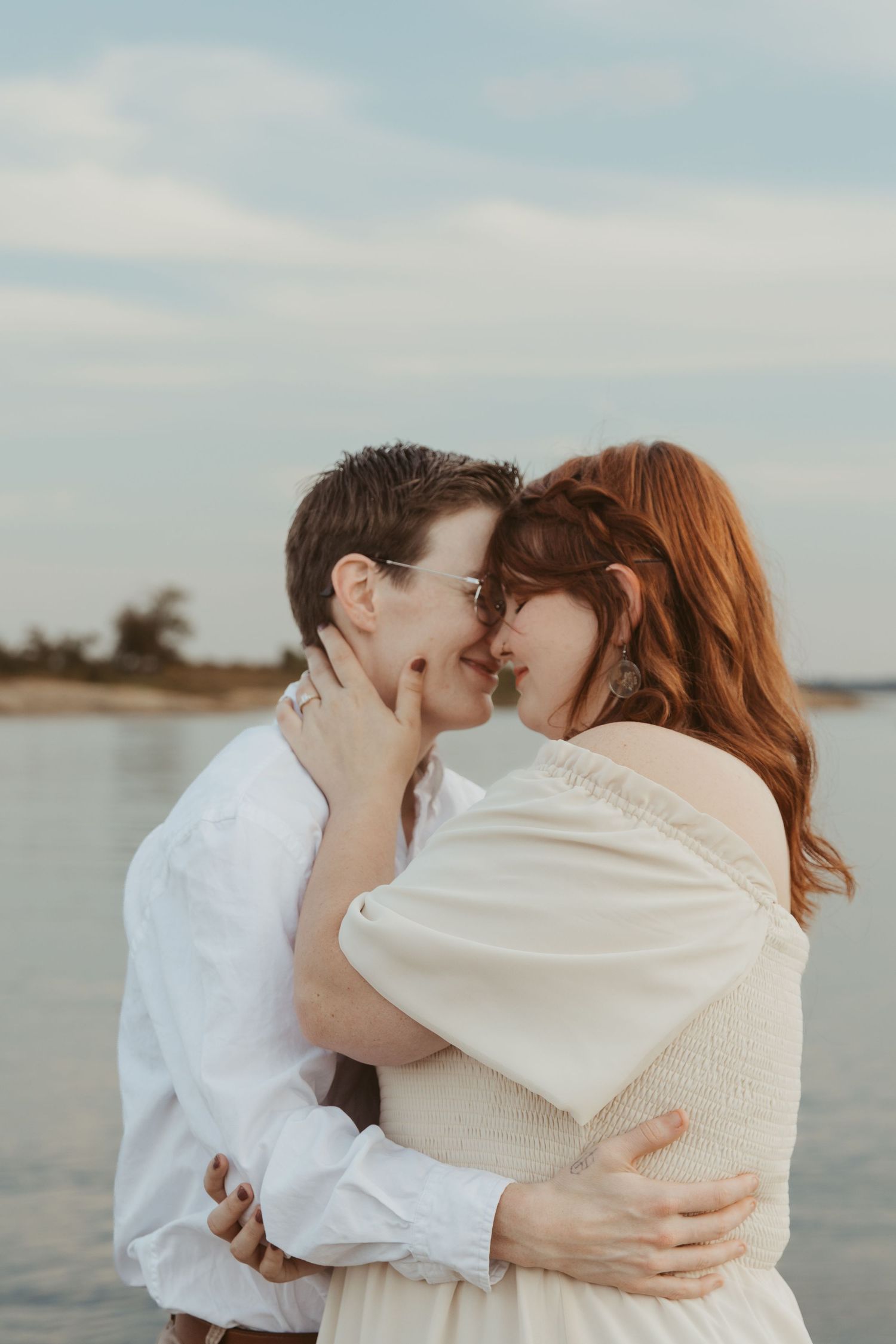 An intimate waterfront moment captured against a serene lake backdrop.