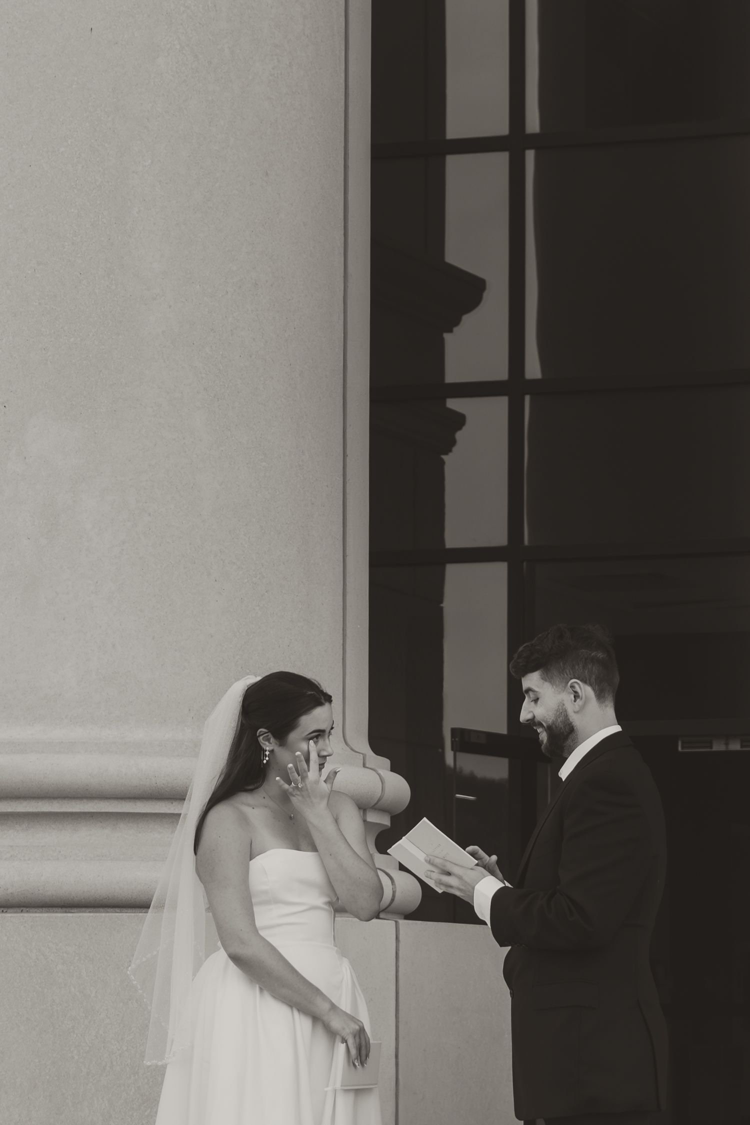 A black and white photo sequence shows a couple sharing a romantic kiss against a wall with windows.