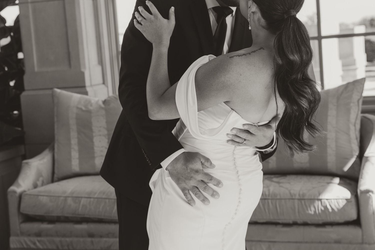A person in a white wedding dress poses in different positions during a bridal photo shoot in an indoor setting.