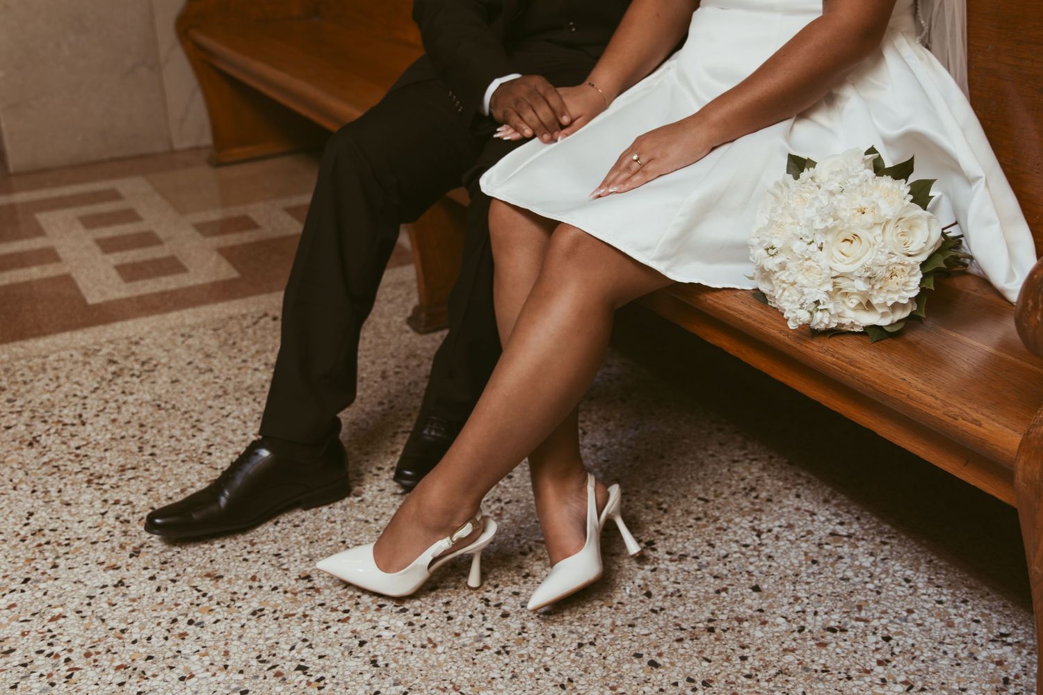 Close-up detail shots of elegant bridal shoes and wedding dress hemlines on a terrazzo floor.
