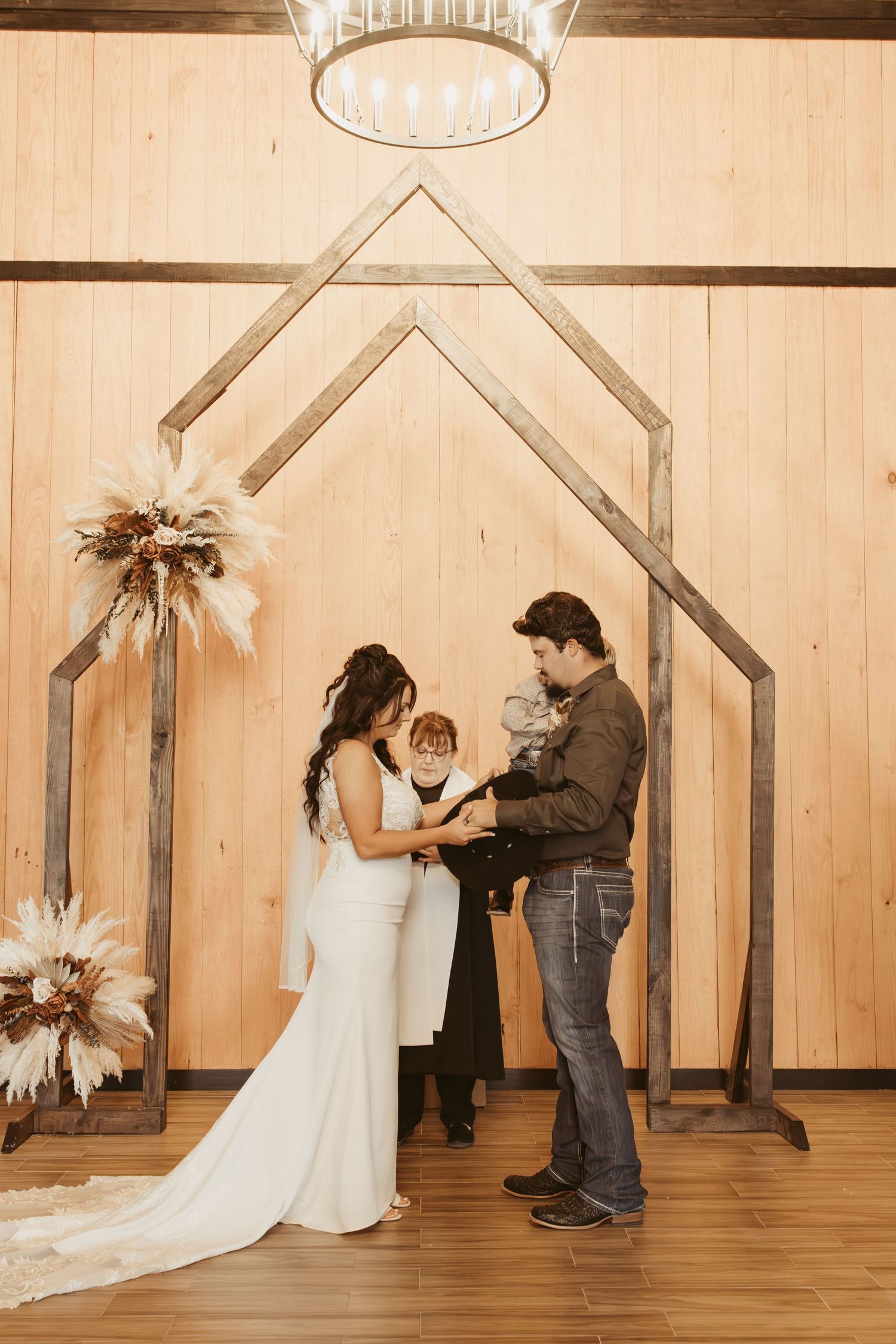 Four sequential photos of a couple during a wedding first look moment in a rustic wooden venue. Wedding photographer DFW