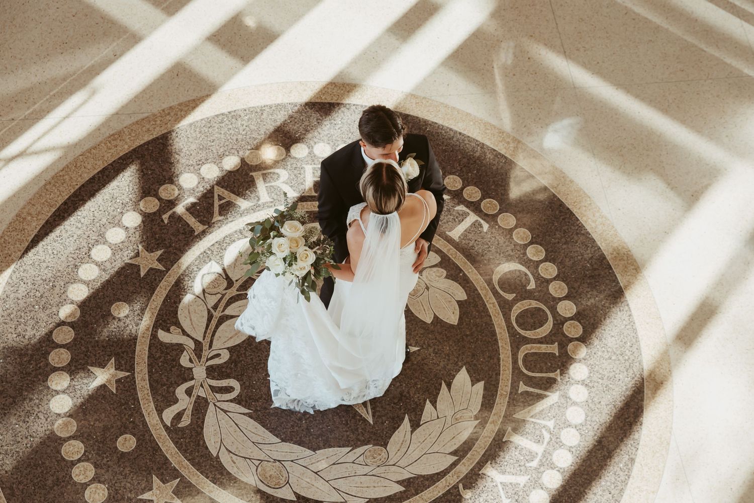 A sepia-toned photo collage showing circular frames with wedding dress details and romantic dance moments.