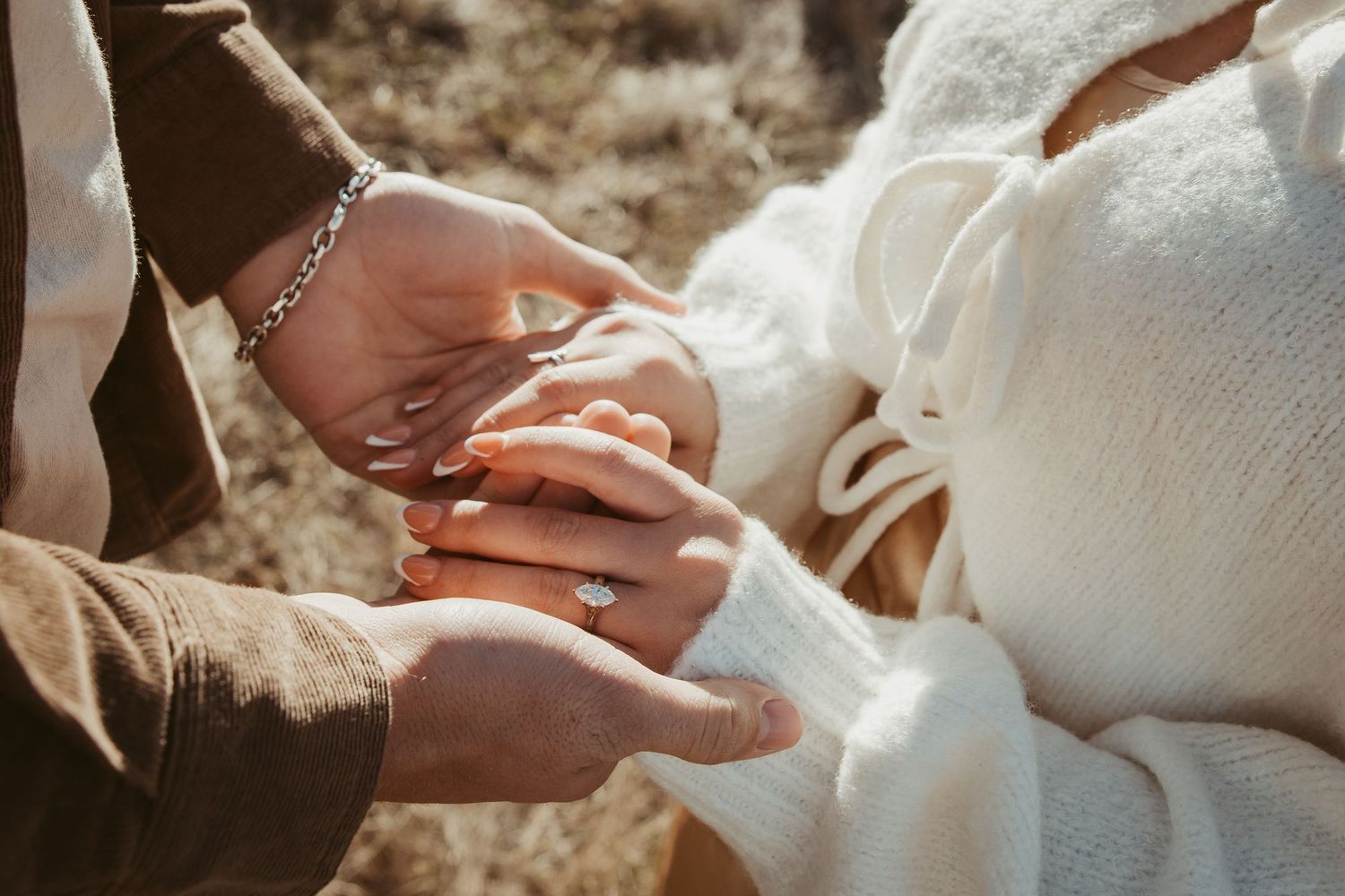 Close-up view of hands exchanging wedding rings during a romantic outdoor ceremony. engagement photos DFW