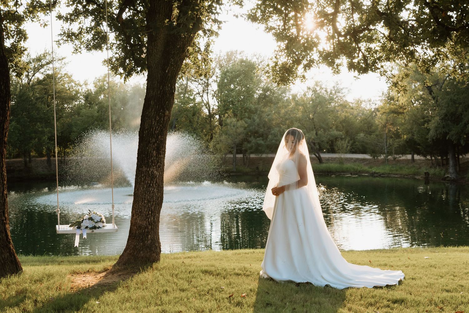 Romantic sunset wedding photos captured along a serene lakeside with golden sunlight filtering through trees.