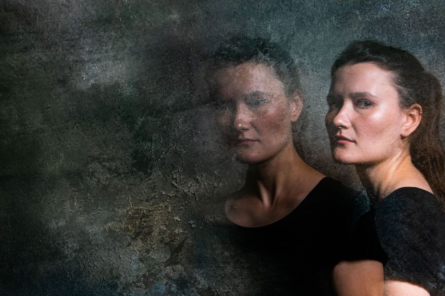 Multiple exposure portrait creating ethereal overlapping effect against dark background.