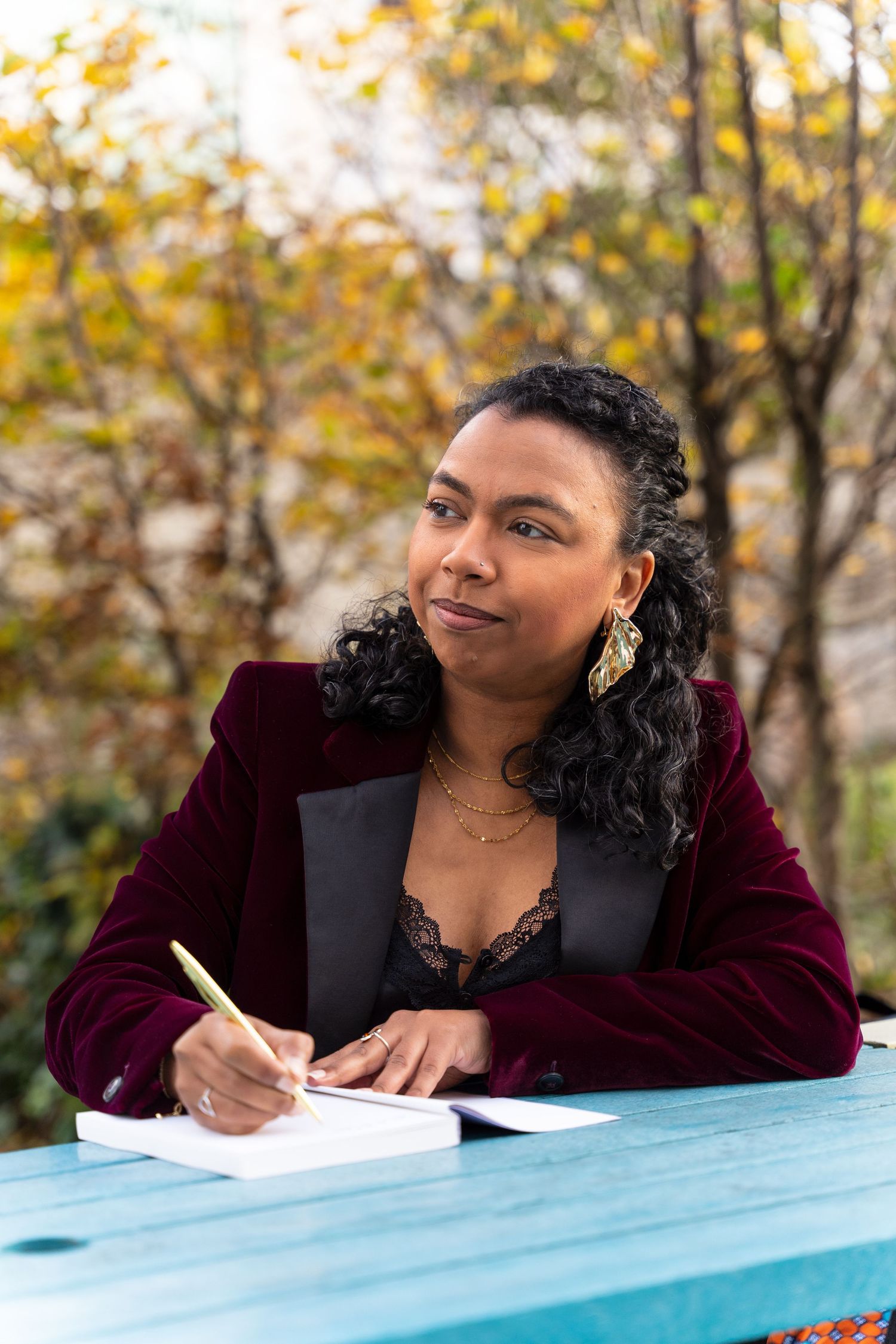 Hampshire-based female entrepreneur makes notes at a table in Southampton during her personal brand photoshoot.