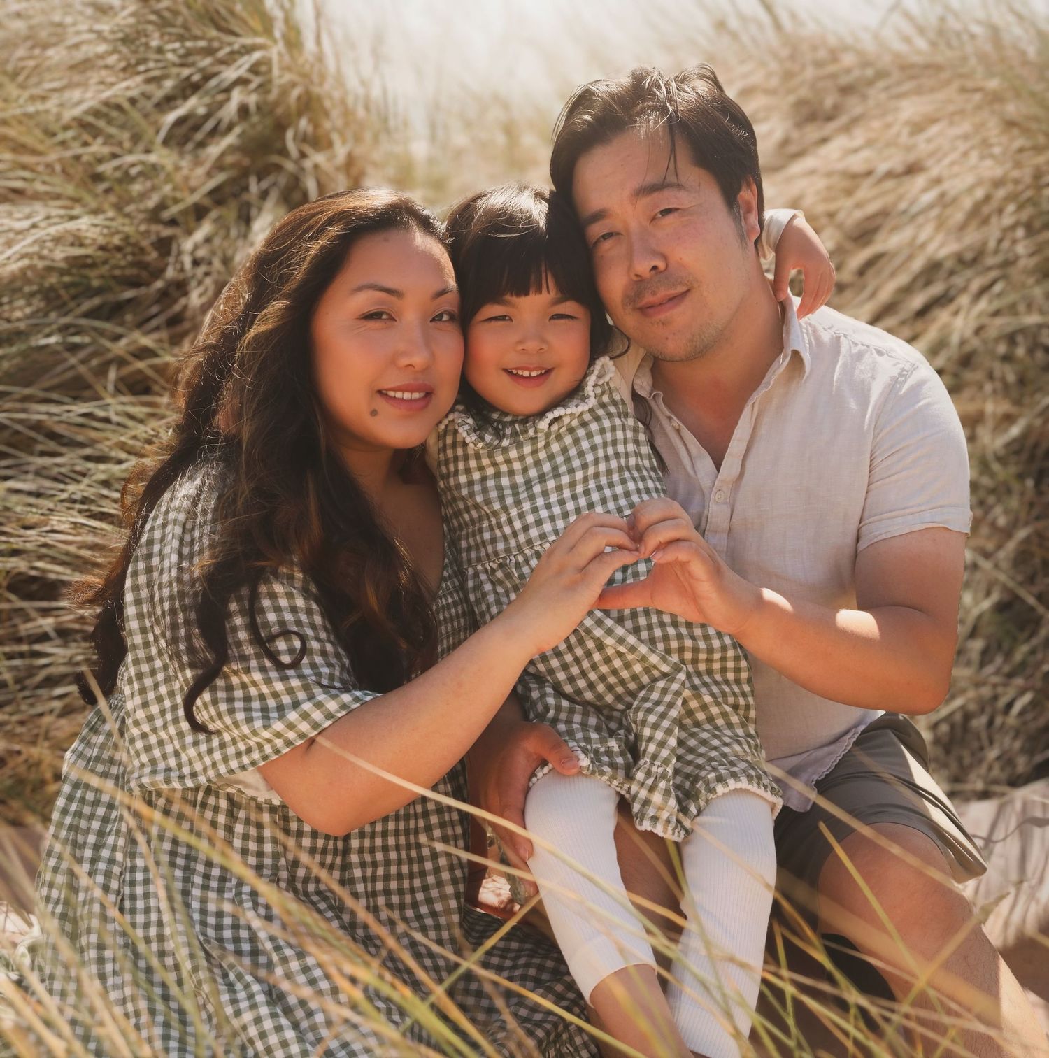 Warm golden hour portrait of a mother and daughter with the sun backlighting their hair, glowing natural light photography in San Francisco.