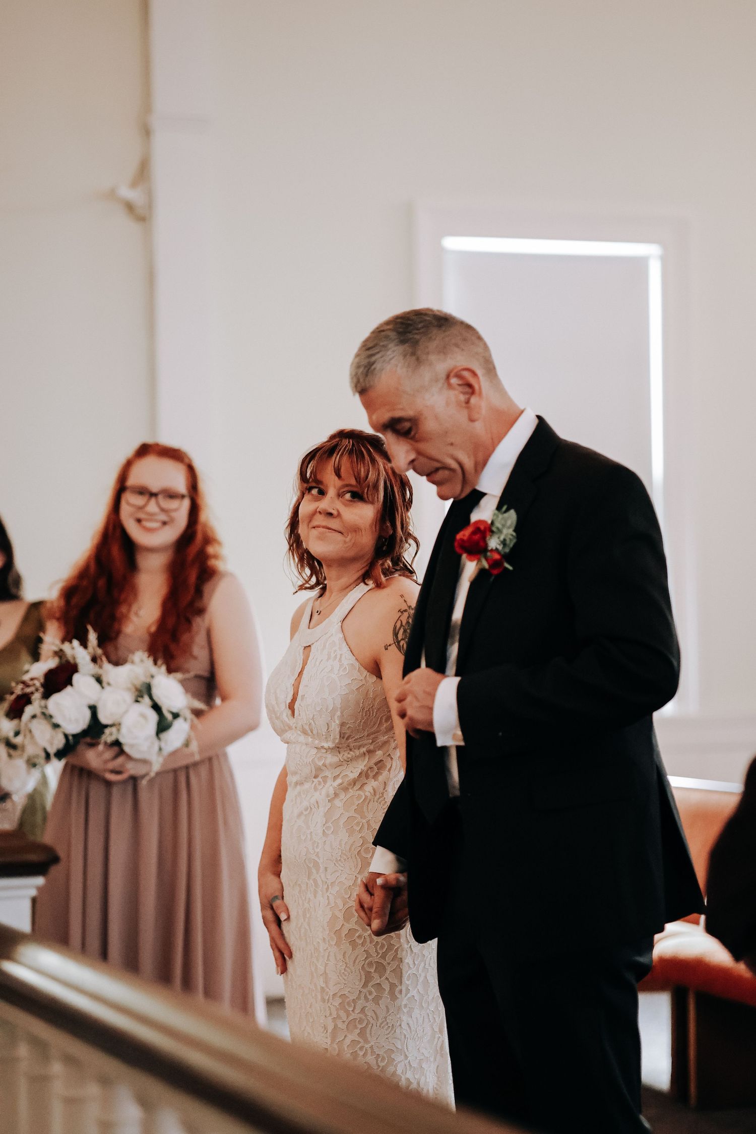 A sequence of wedding photos showing an emotional father-daughter first look moment in a light-filled venue.