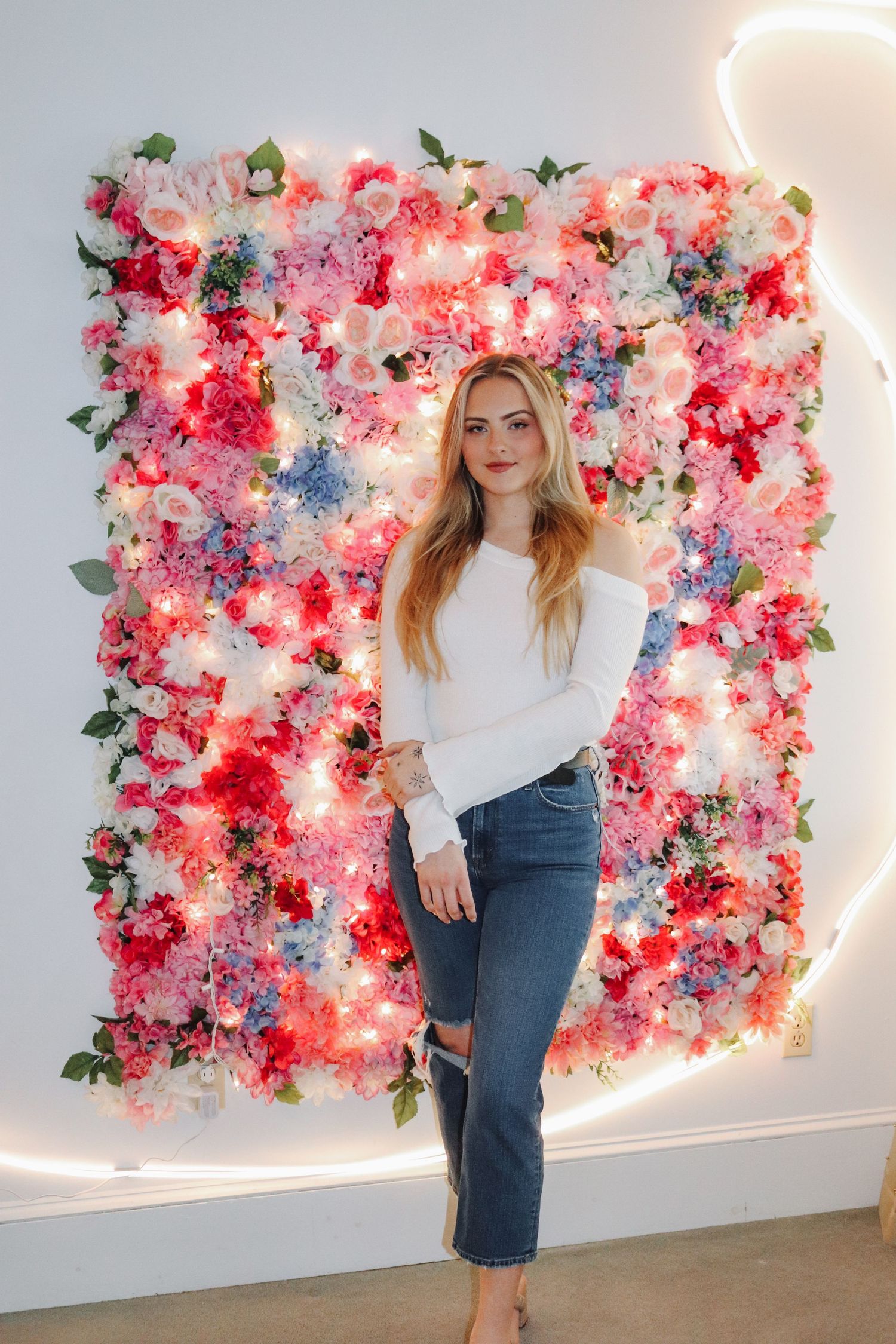 A floral wall installation backdrop in an indoor setting.