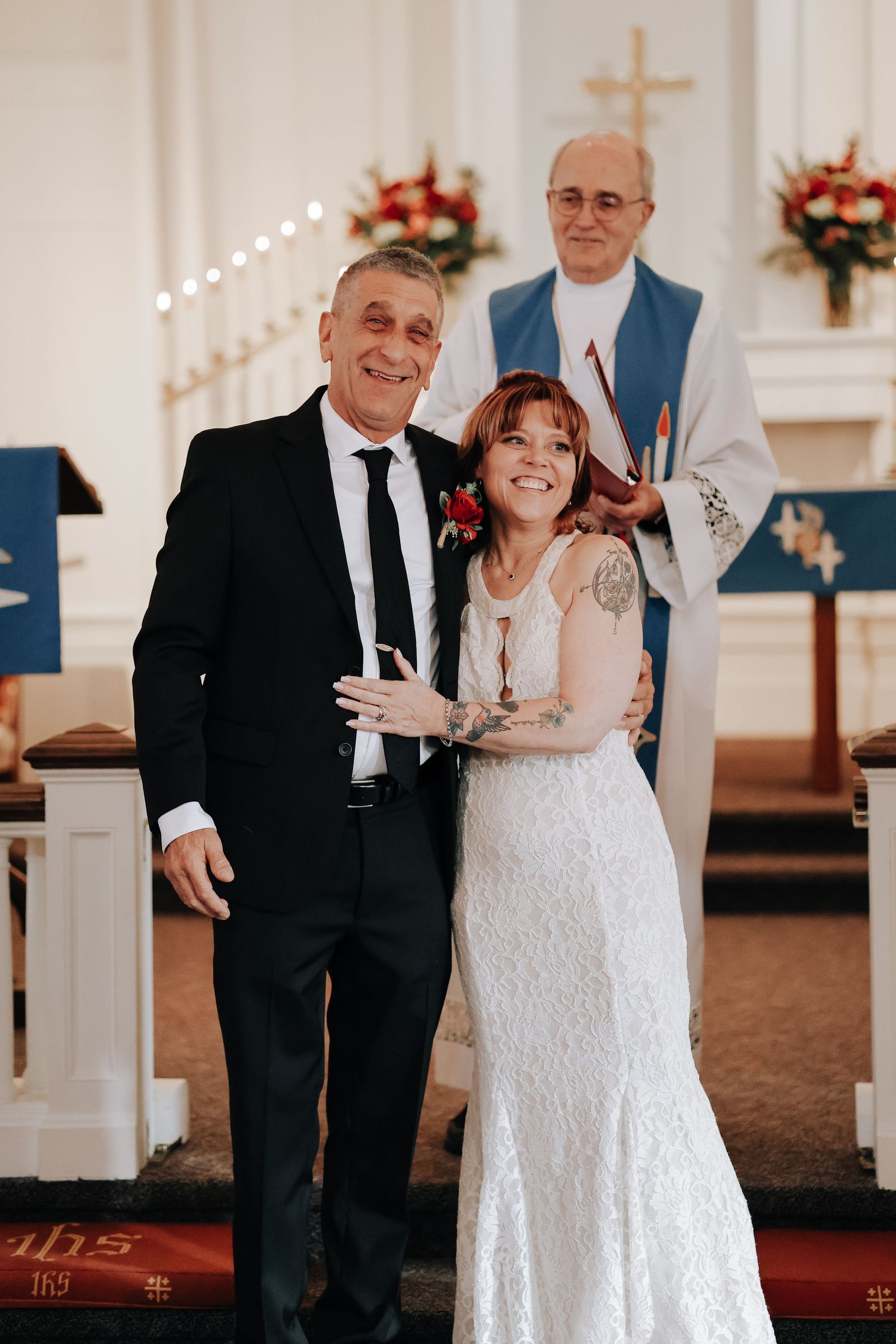 A couple shares joyful moments during their wedding ceremony in a church.