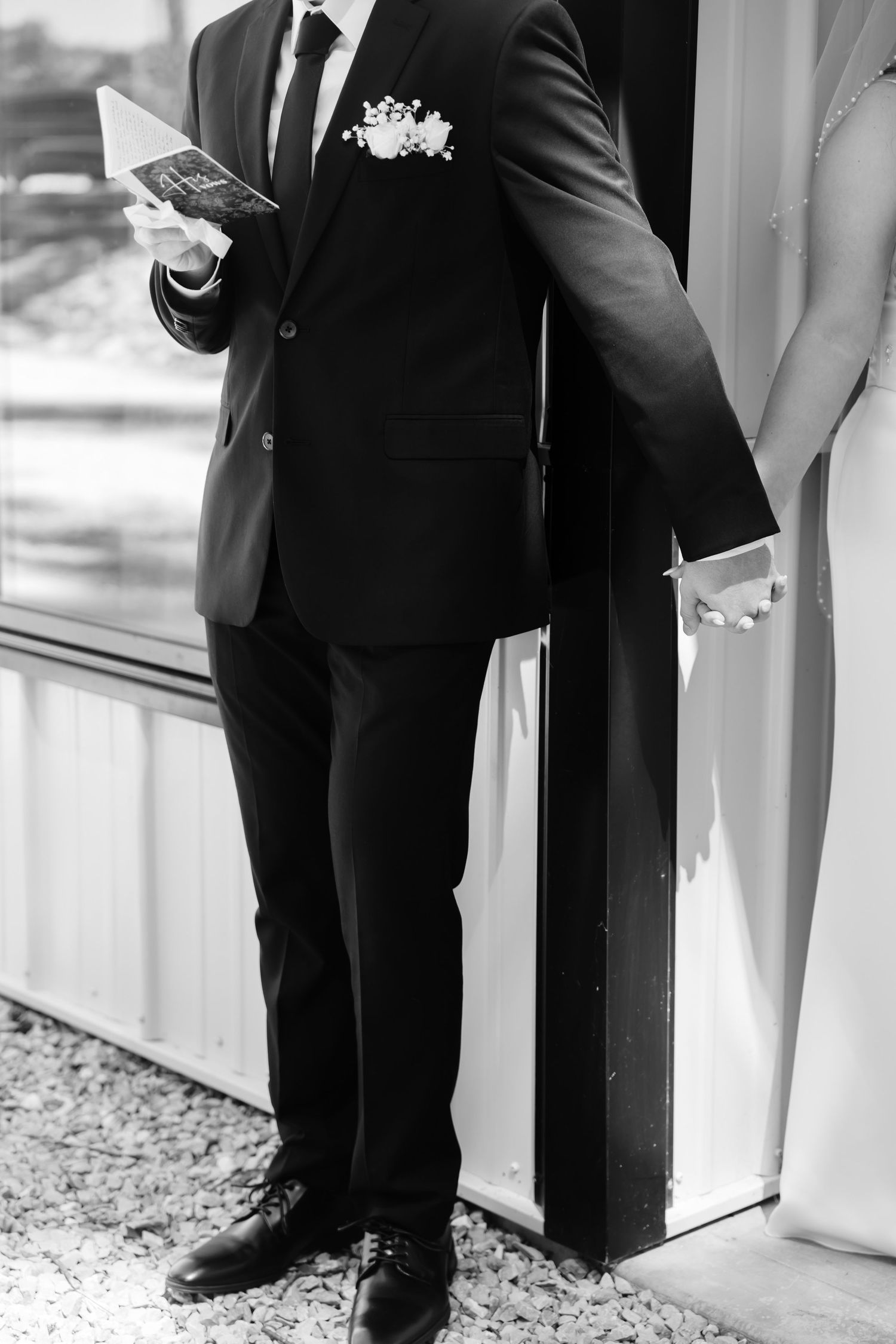 Wedding ceremony detail shot showing formal attire and decor elements.