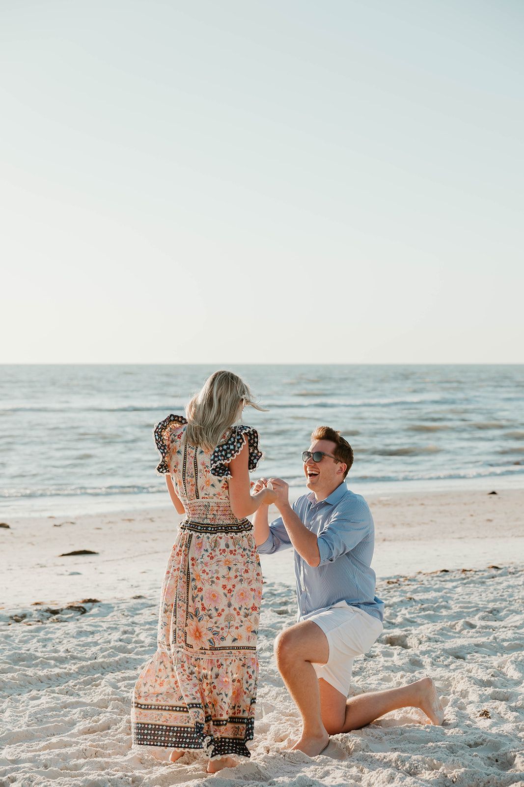 A beachside proposal moment captured in a series of photos showing the emotional reaction.