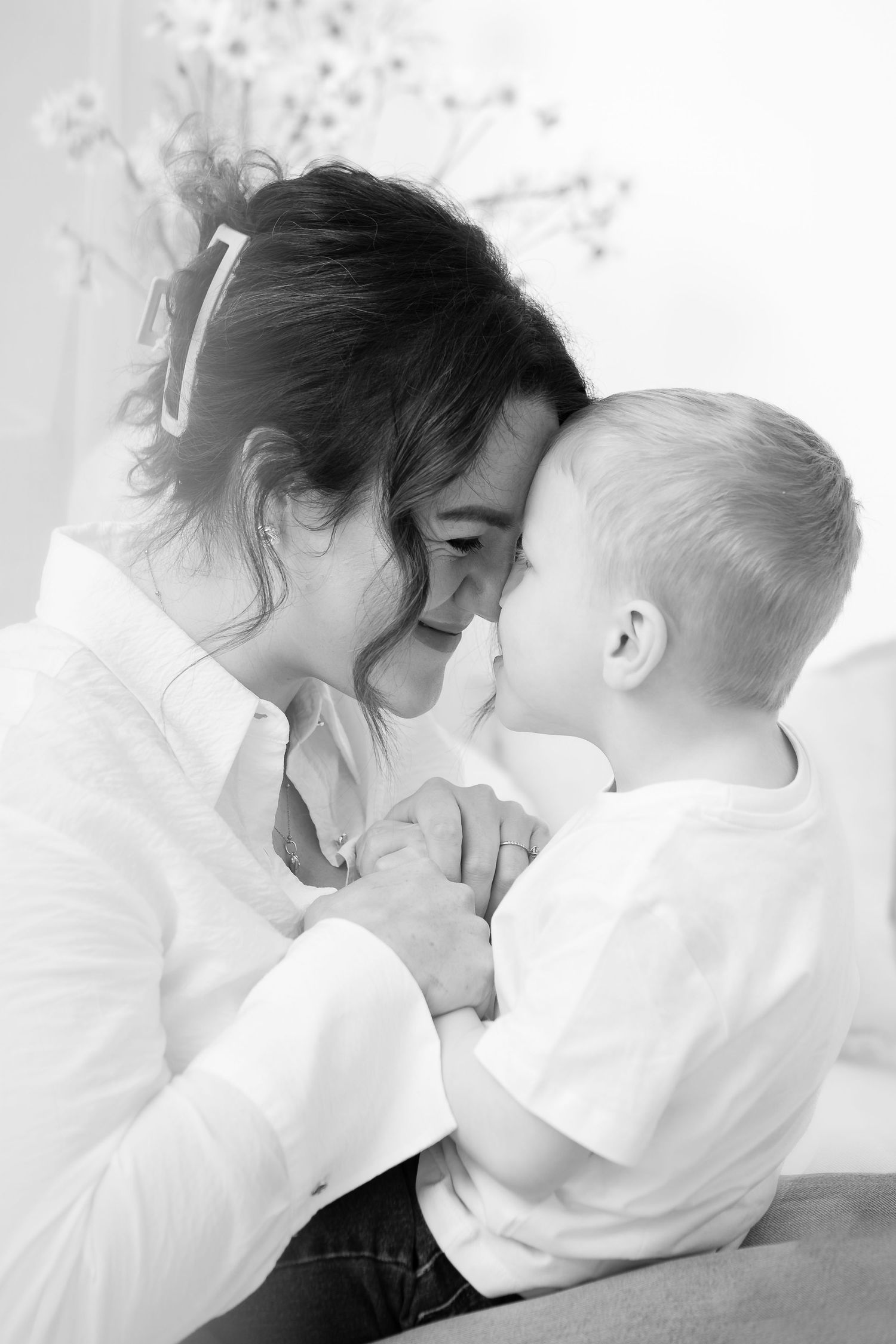 Black and white intimate portrait series of parent and child sharing affectionate moments.