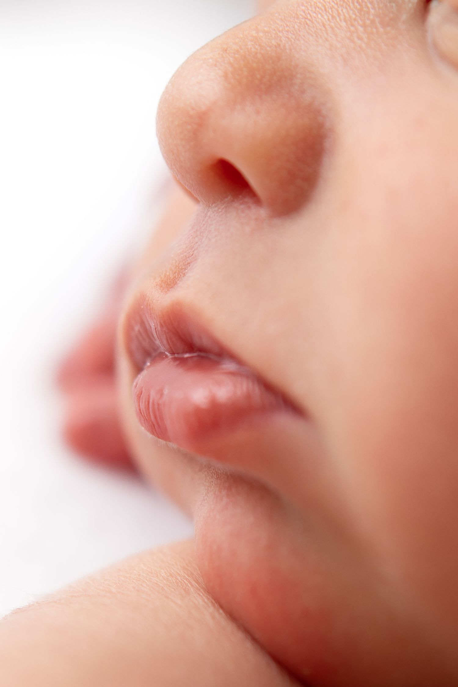 Extreme close-up series of a baby's delicate facial features and lips.