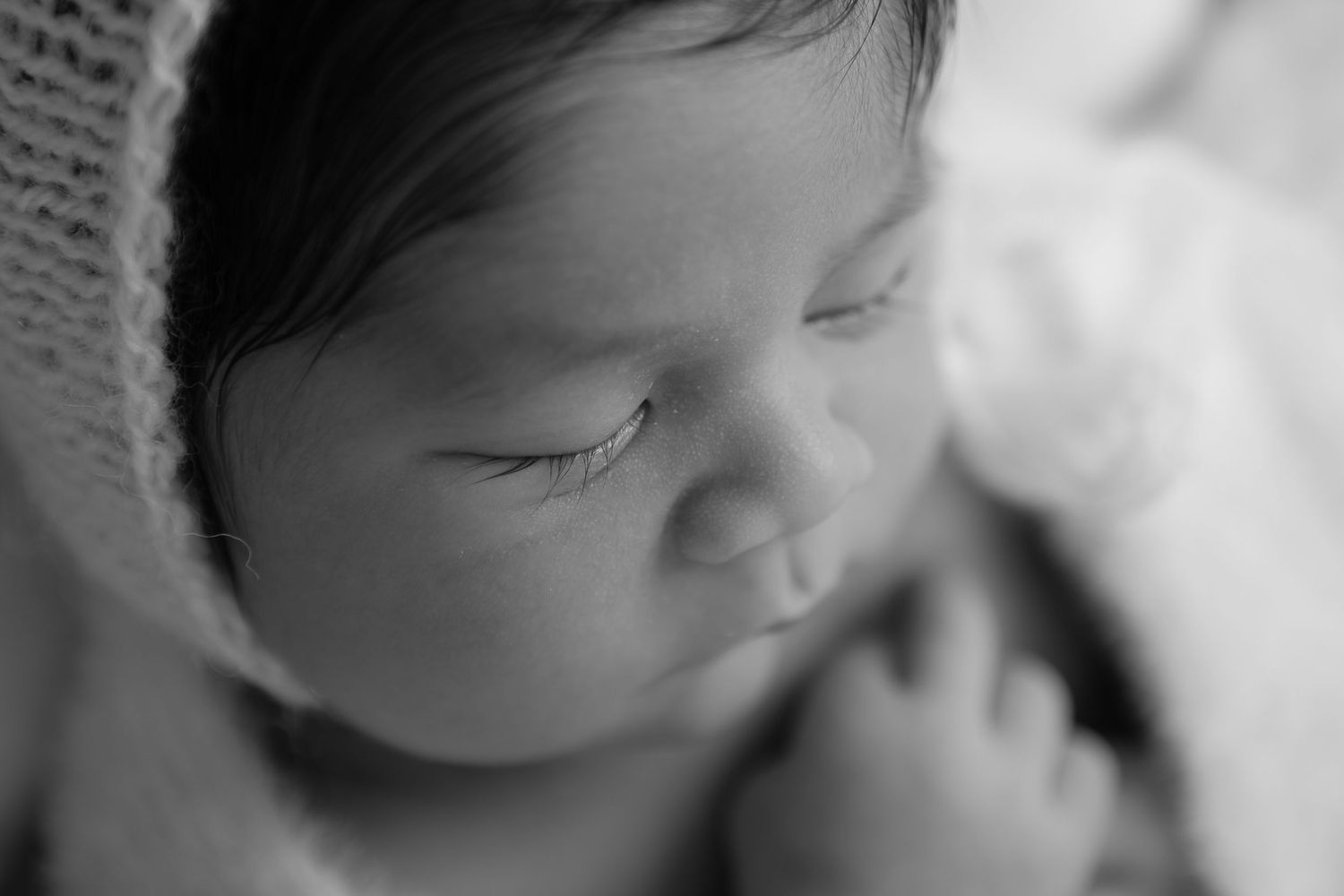 Black and white series of artistic newborn portraits in soft focus.