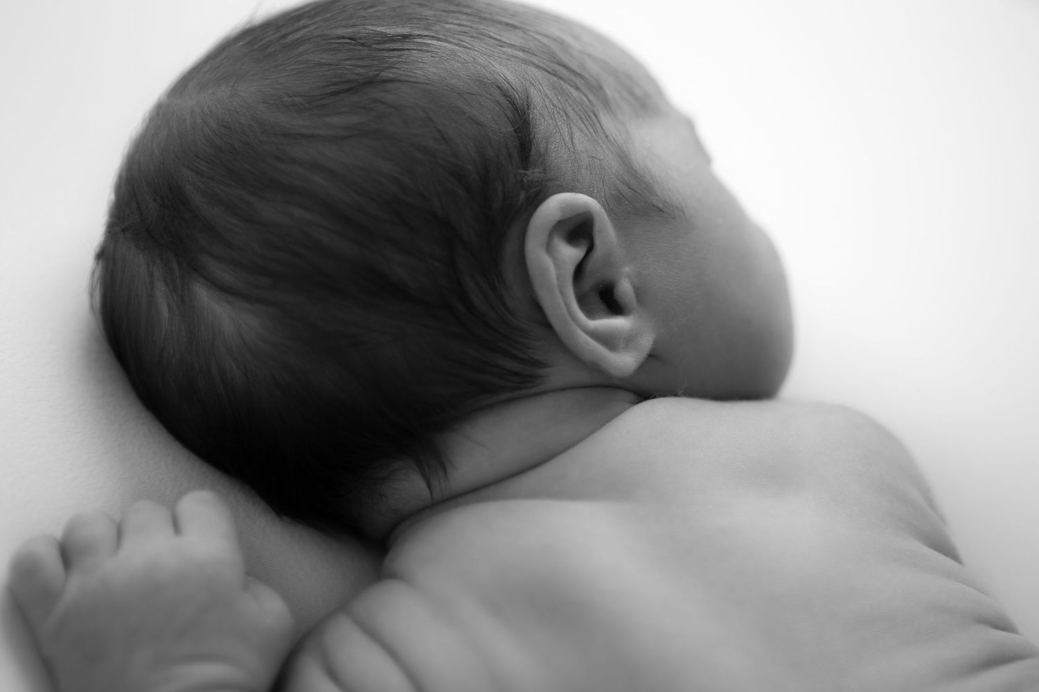 Series of artistic black and white profile shots showing sleeping newborn.