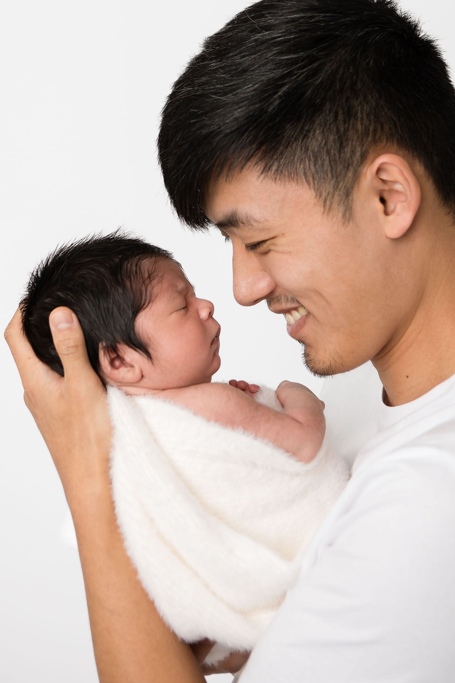 Black and white photo sequence capturing intimate bonding moments with a newborn.