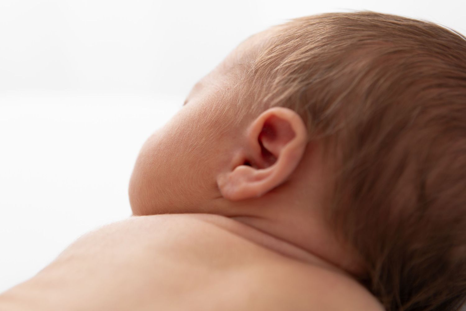 Artistic series showing close-up details of sleeping newborn.