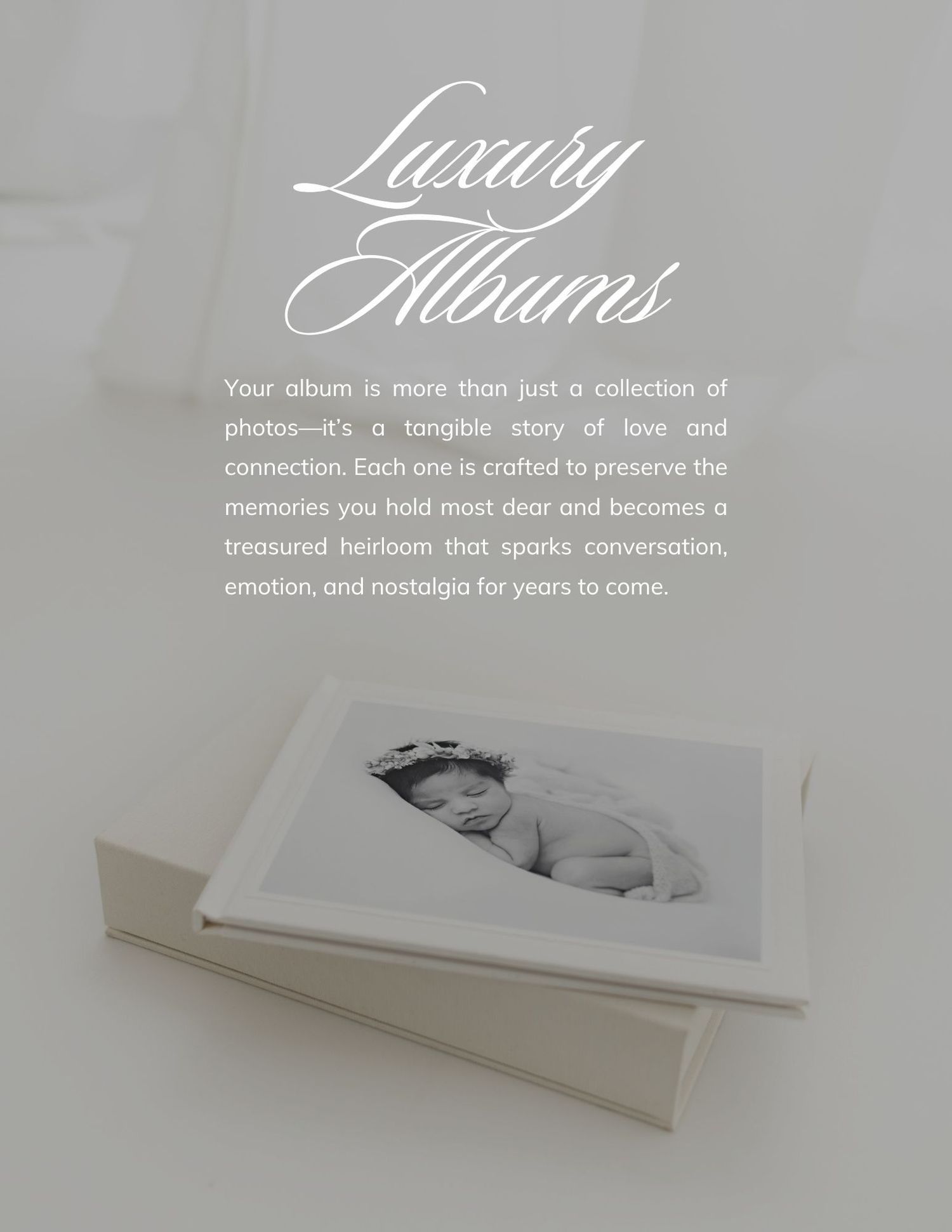 Luxury photo album with black and white newborn baby portrait, elegant white cover, showcasing heirloom quality photography keepsake.
