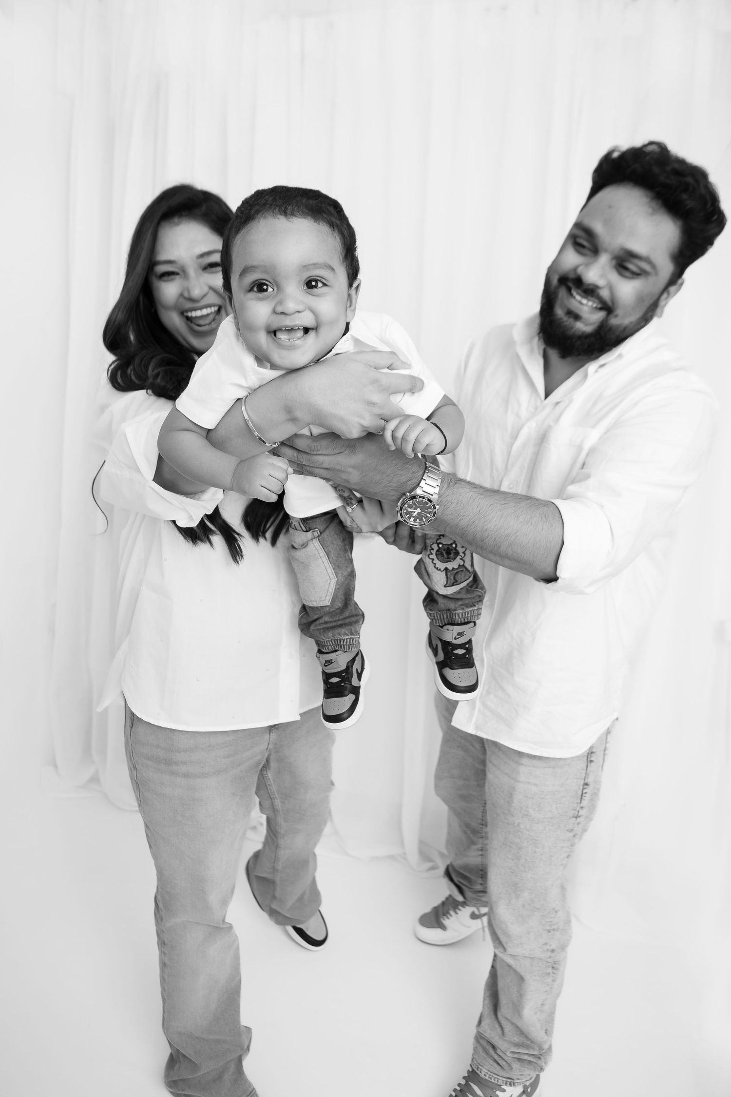 Playful family photography sequence with natural interactions in studio.