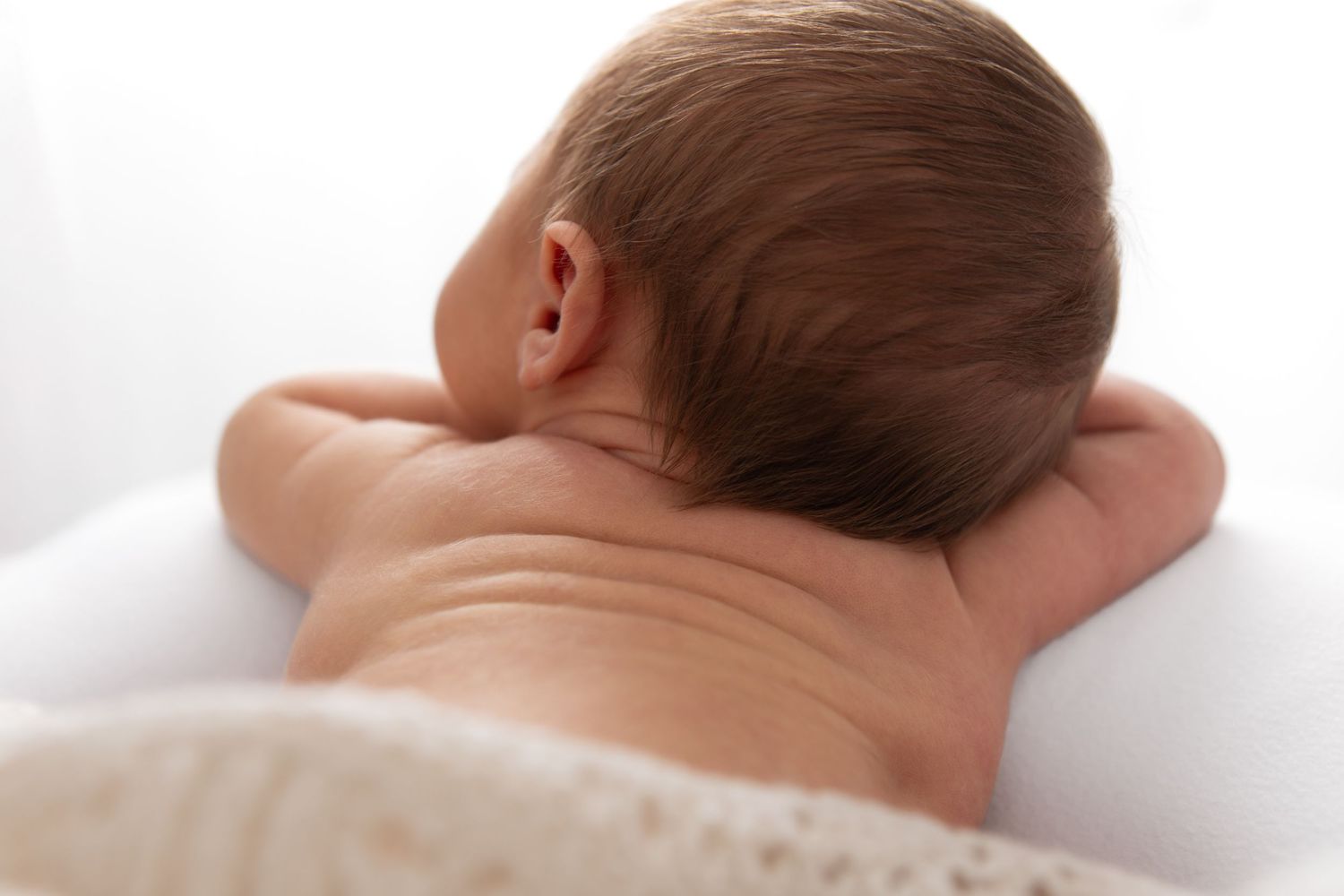 Series of close-up shots showing baby's head and hair against white background.