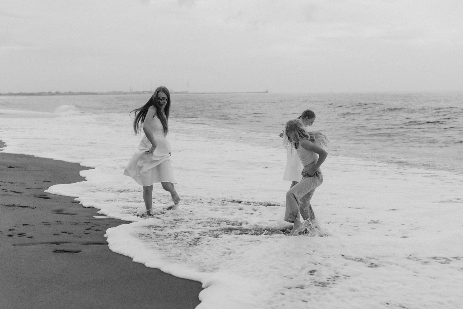 People playing and splashing in ocean waves at the beach.