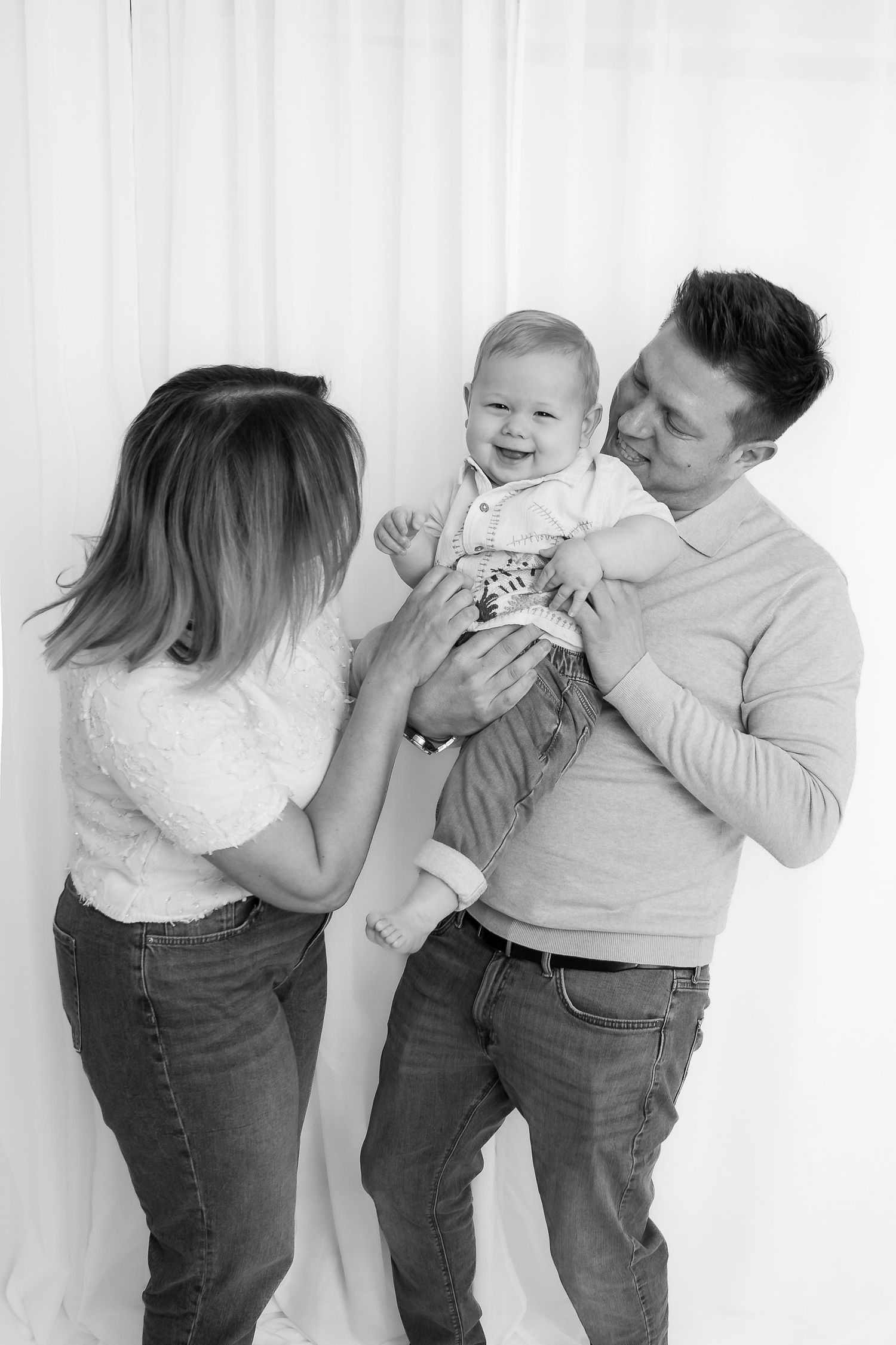 Candid black and white family photos showing playful interactions and laughter.