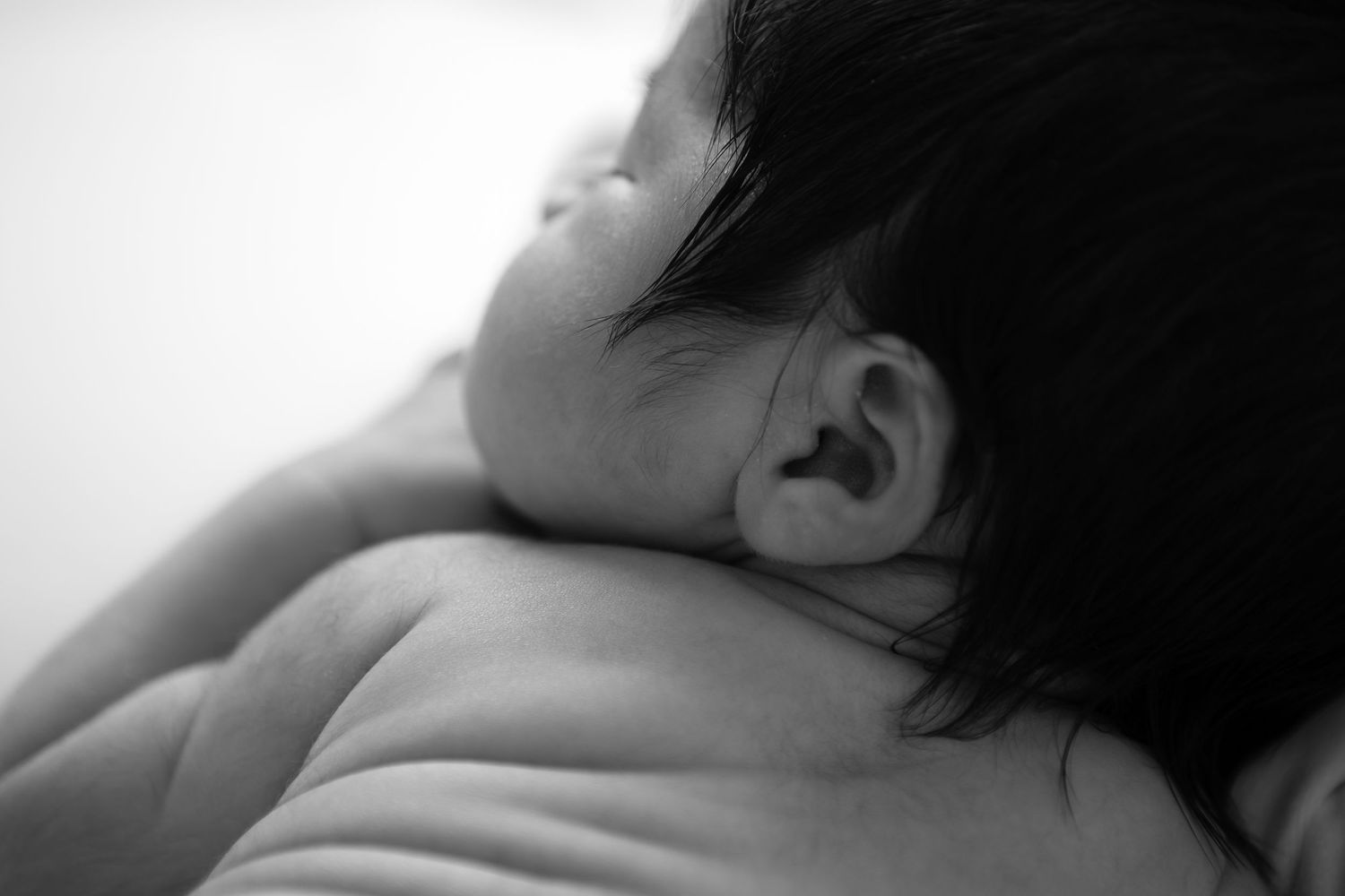 Artistic black and white close-up of sleeping newborn baby.
