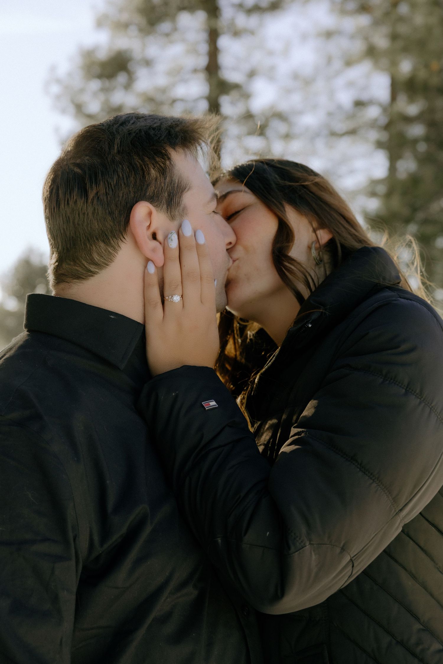 A romantic couple shares intimate kisses in a series of four connected photos taken outdoors in soft natural lighting.