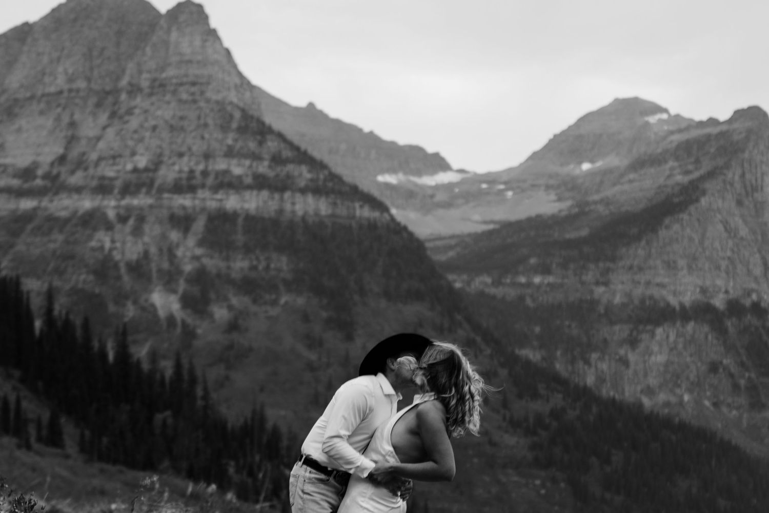 A series of black and white landscape photographs showing rugged mountain peaks and valleys in Glacier National Park.
