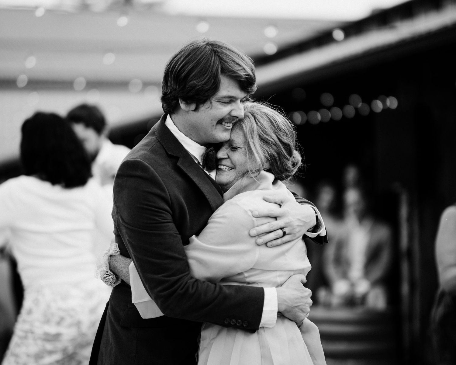 Black and white romantic embrace captured in dramatic lighting.