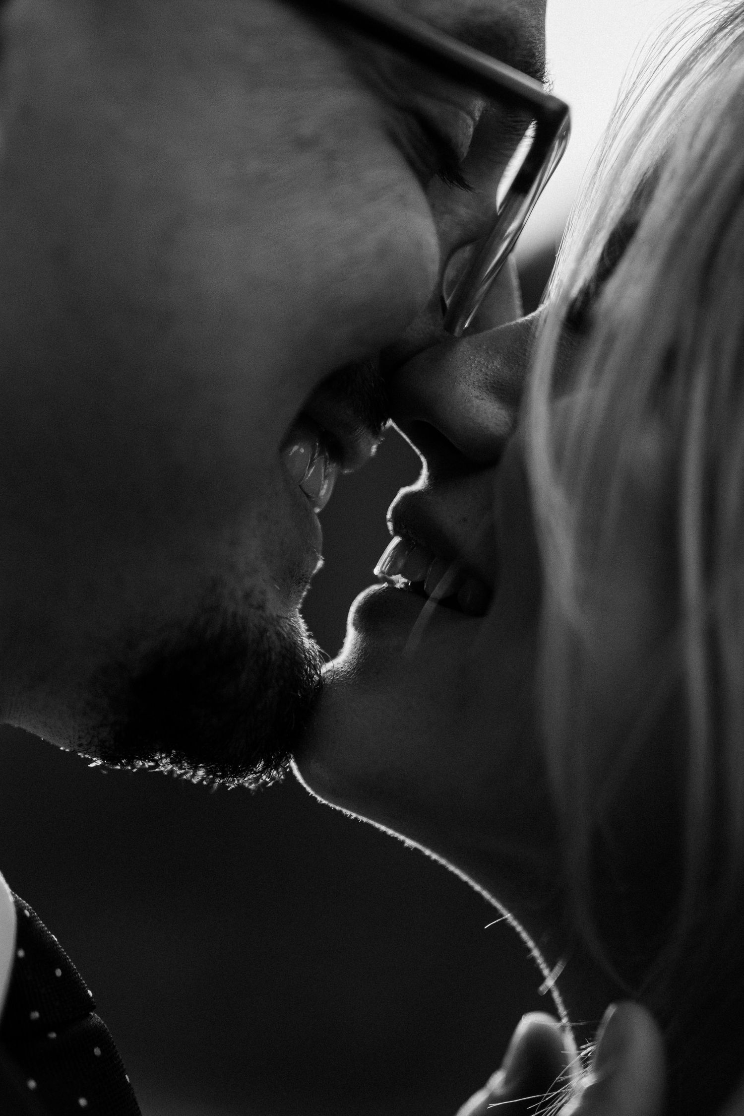 A romantic black and white silhouette photo sequence shows a couple sharing an intimate kiss.
