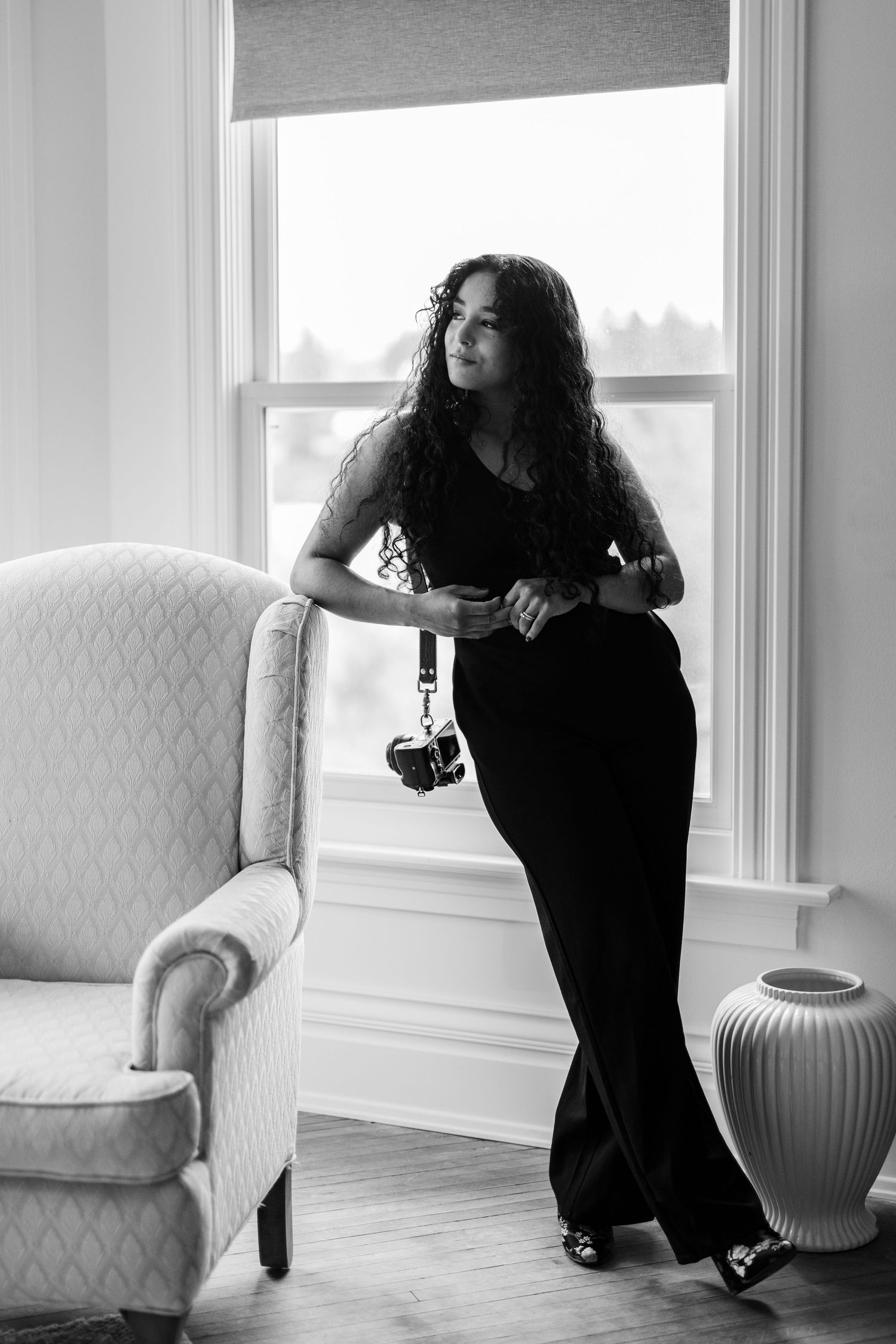 Series of artistic black and white portraits in a bright white interior room.