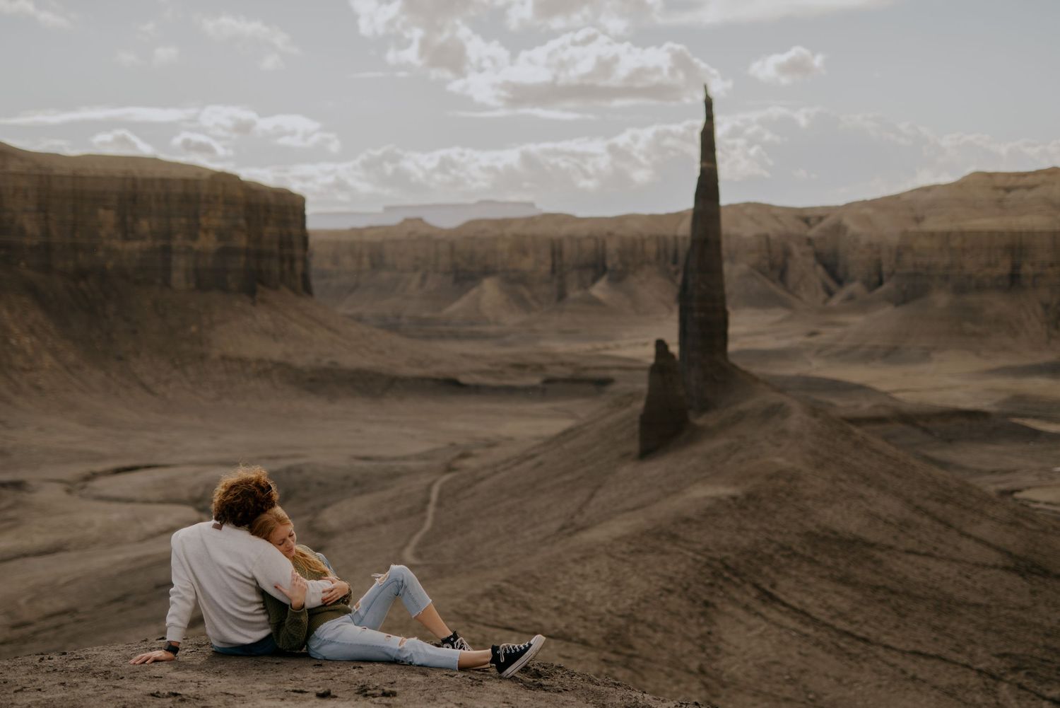 Desert landscape photography series featuring dramatic rock formations and mountains under cloudy skies.
