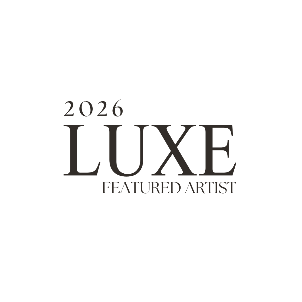 A minimalist black and white text design featuring the word LUXE and '2026 FEATURED ARTIST' in elegant typography.