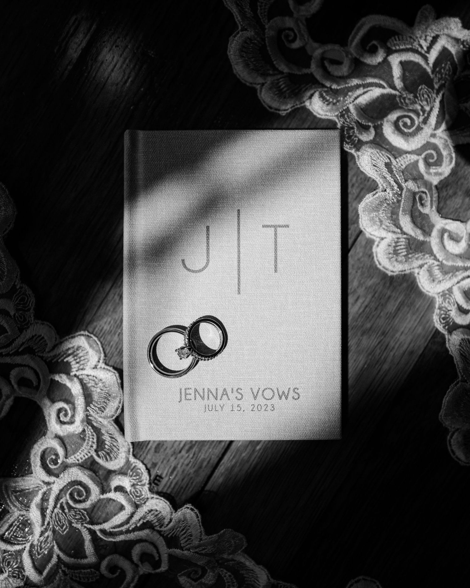 Black and white wedding stationery with elegant lace details and typography.