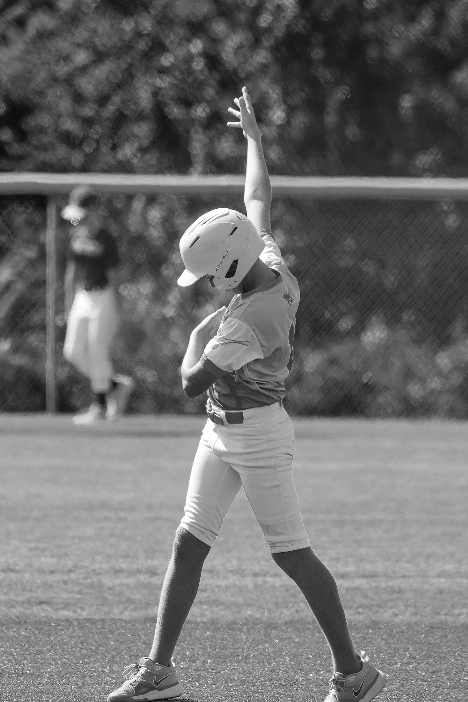 A sequence of black and white photos showing a baseball player's hitting celebration