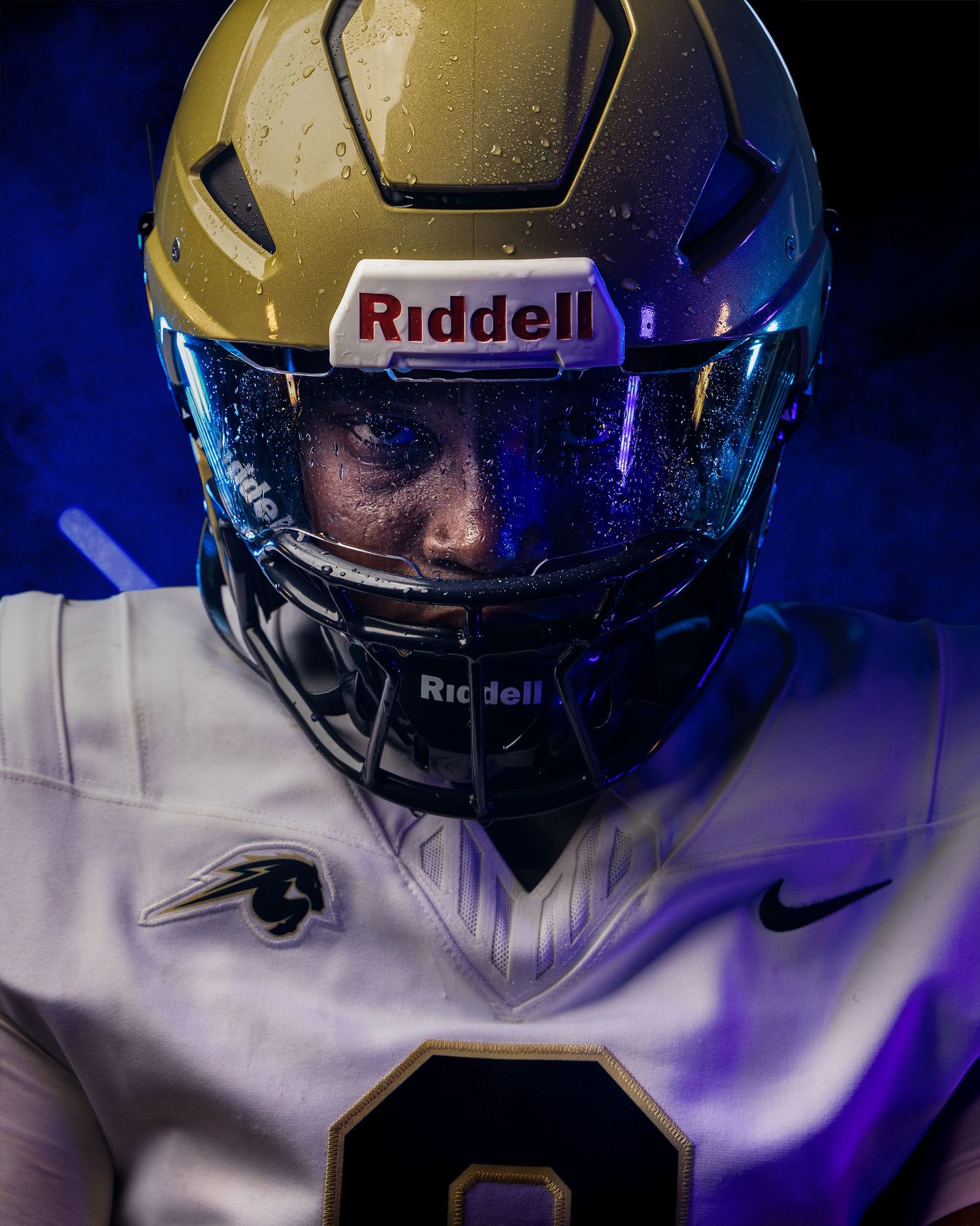 Close-up shots of a gold football helmet with Riddell branding shown from multiple angles in dramatic blue lighting.