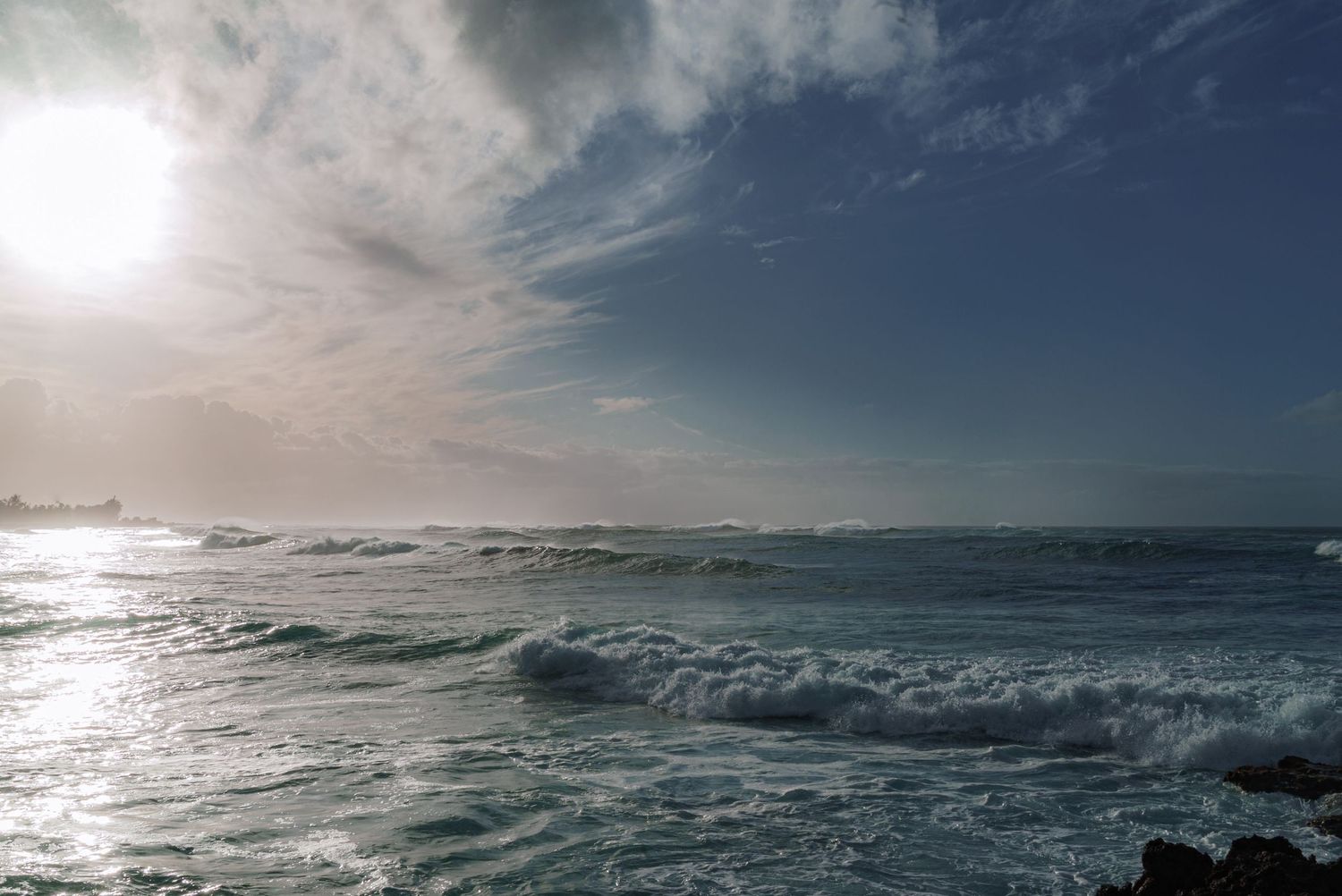 a landscape photo of the clouds, the blue sky and the setting sun over the ocean in hawaii