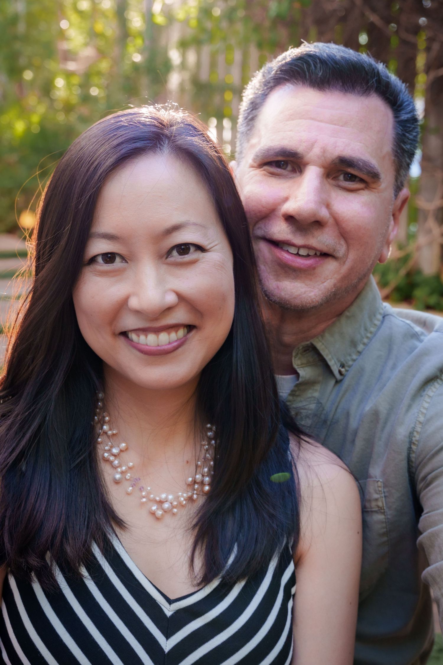 a couples portrait of an engaged couple at golden hour in front of a bamboo forest