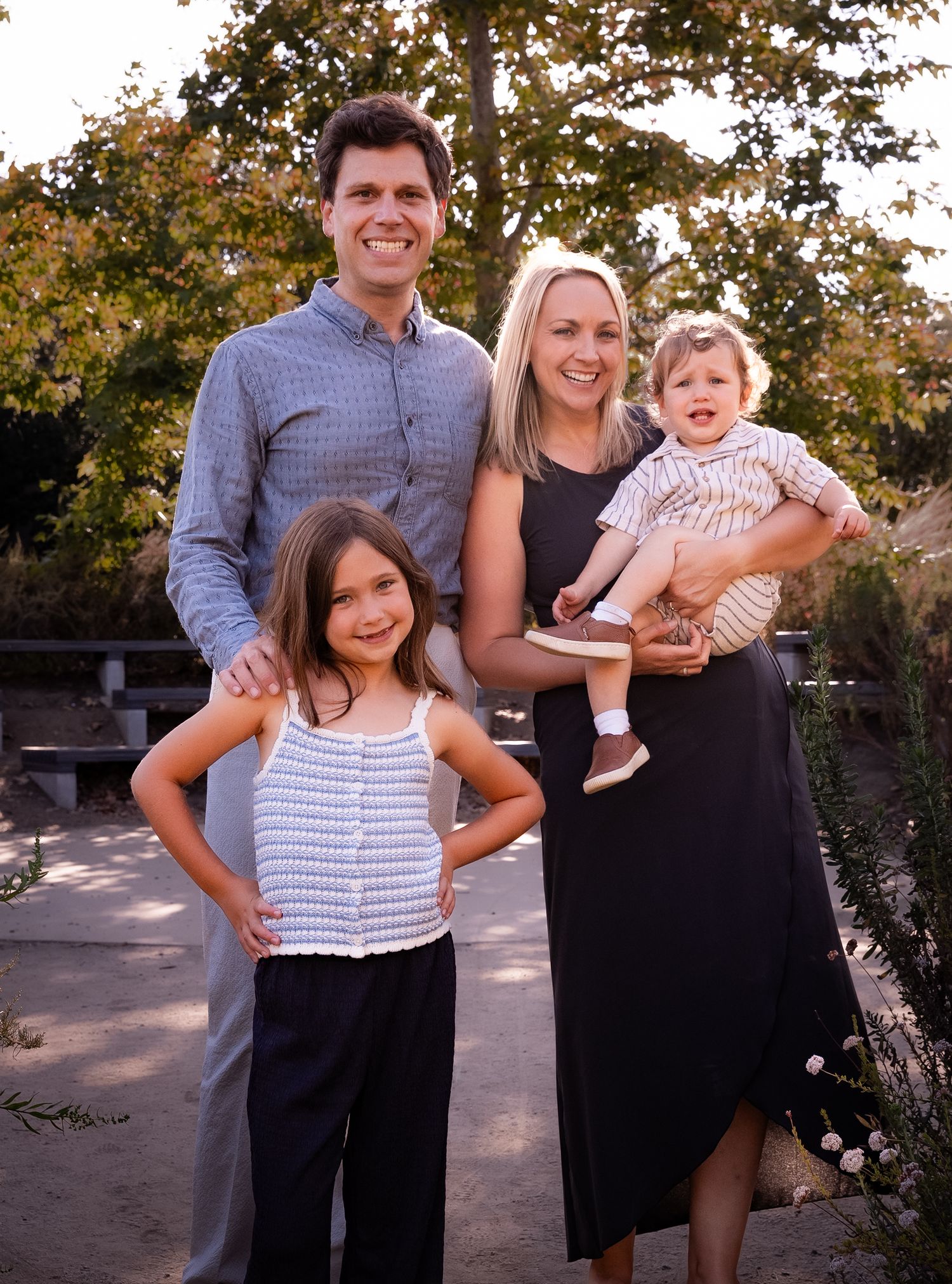 a relaxed family portrait of a family of four at the park in playa vista