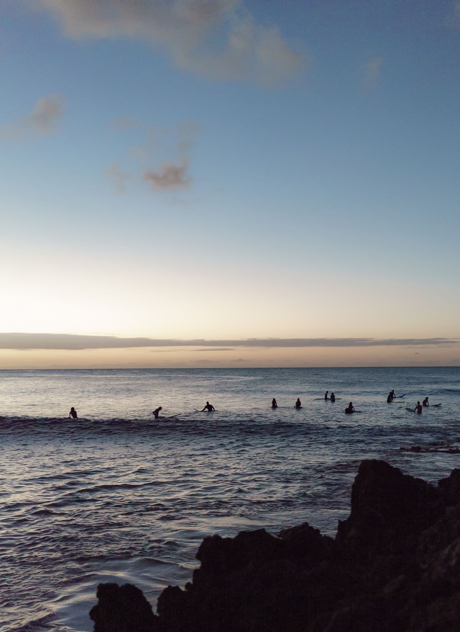 A quiet moment during sunset in the North Shore of Oahu where surfers wait for a wave