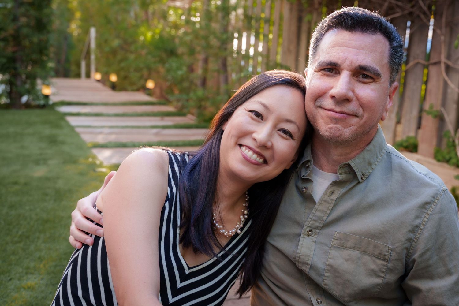 a couples portrait of a engaged couple snuggling at a park
