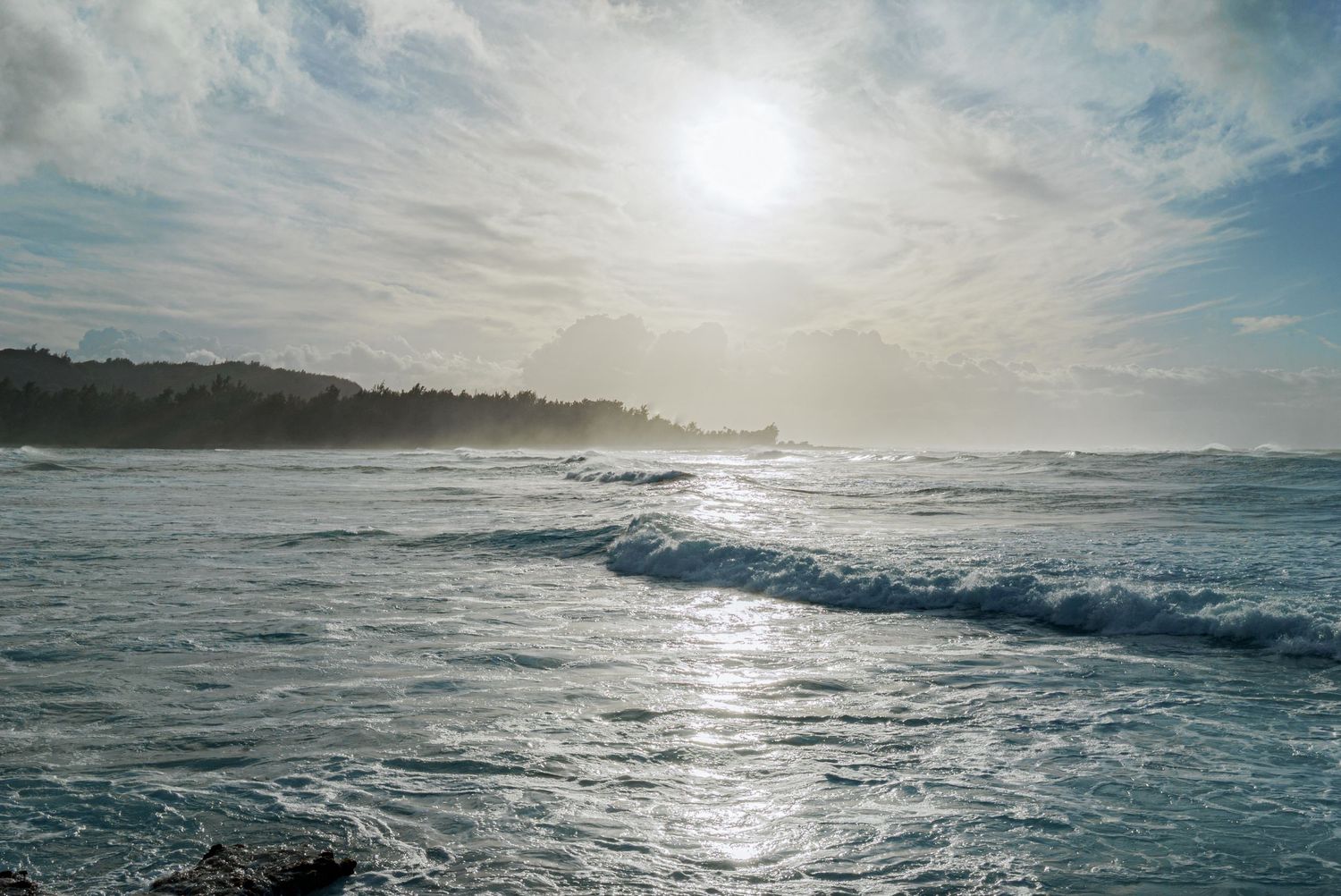 a landscape photo of the clouds, the setting sun and the ocean in hawaii at Sunset