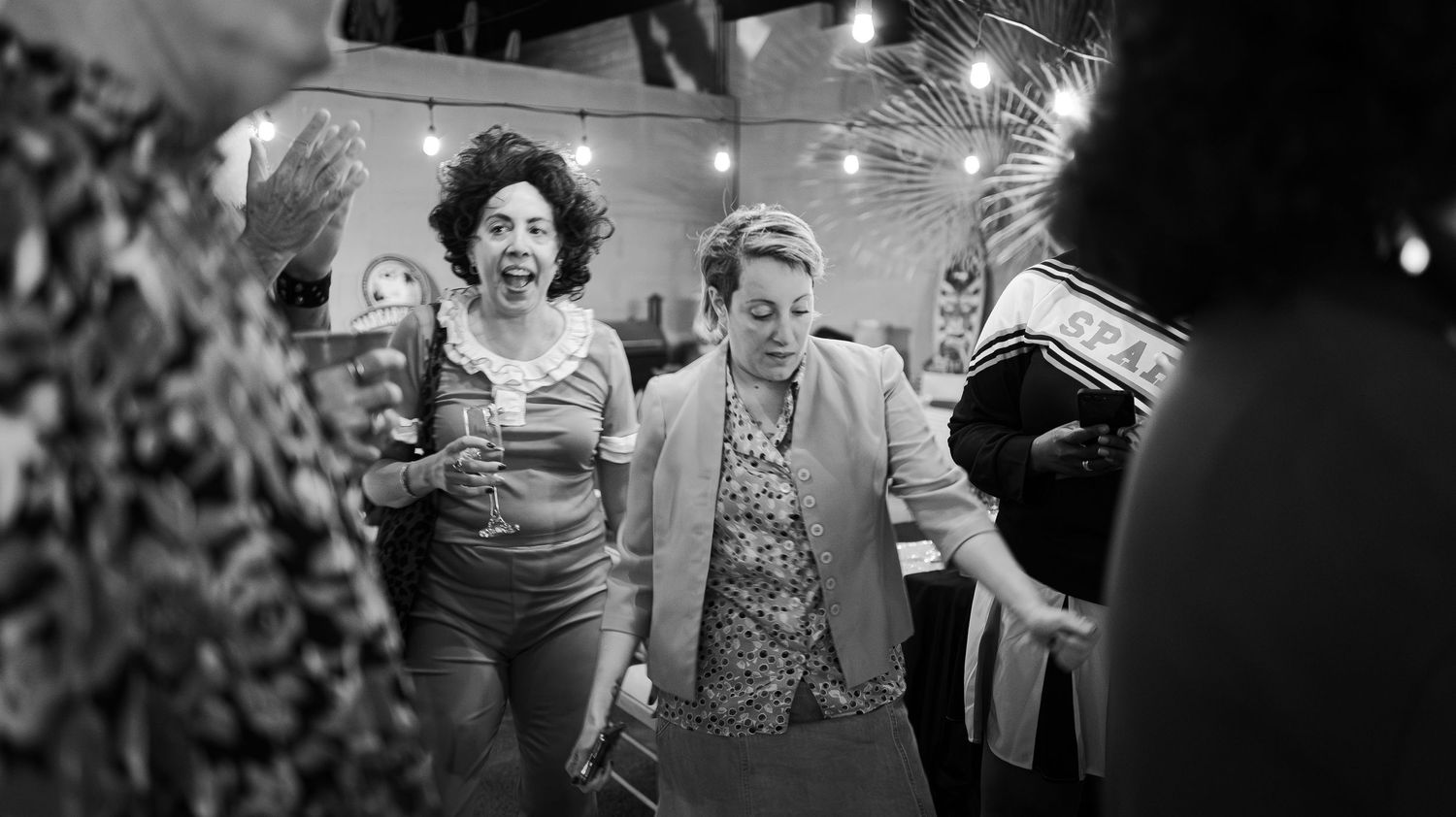 Black and white photos showing a lively indoor celebration with dancing and festive lighting.