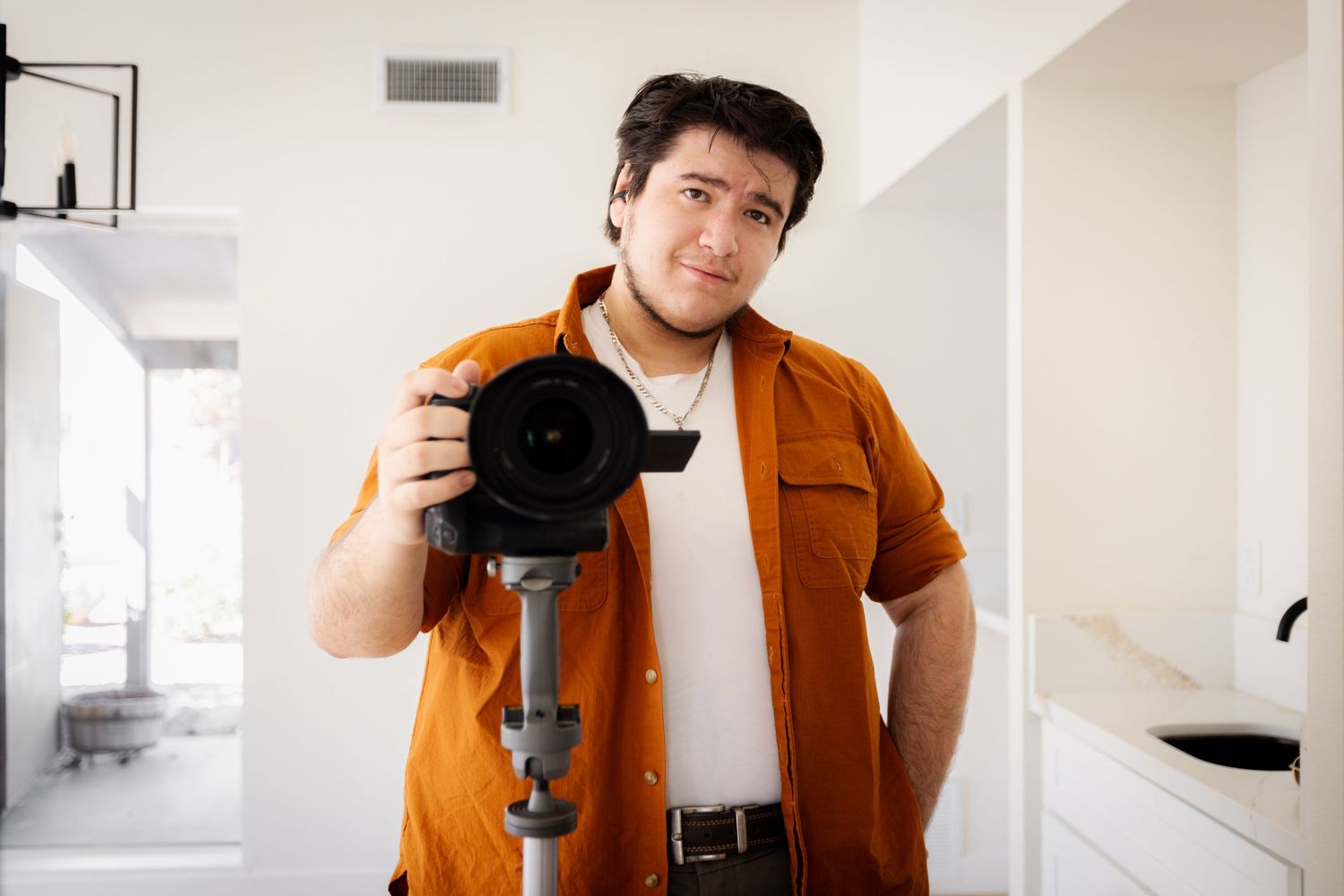Collage of photography poses showing camera handling techniques against white walls.