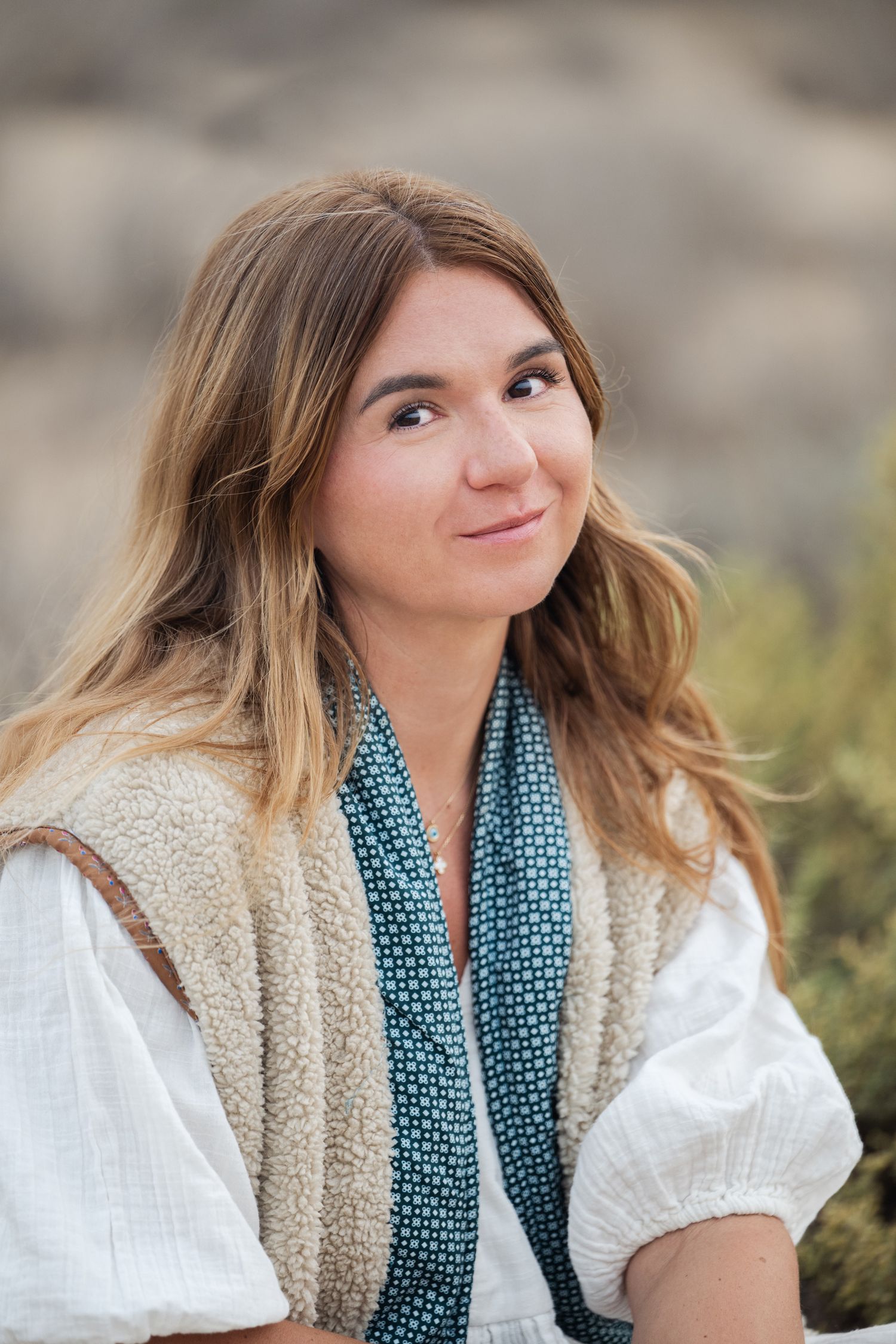 A series of outdoor portrait shots showing someone in a white top and teal scarf against a natural background.